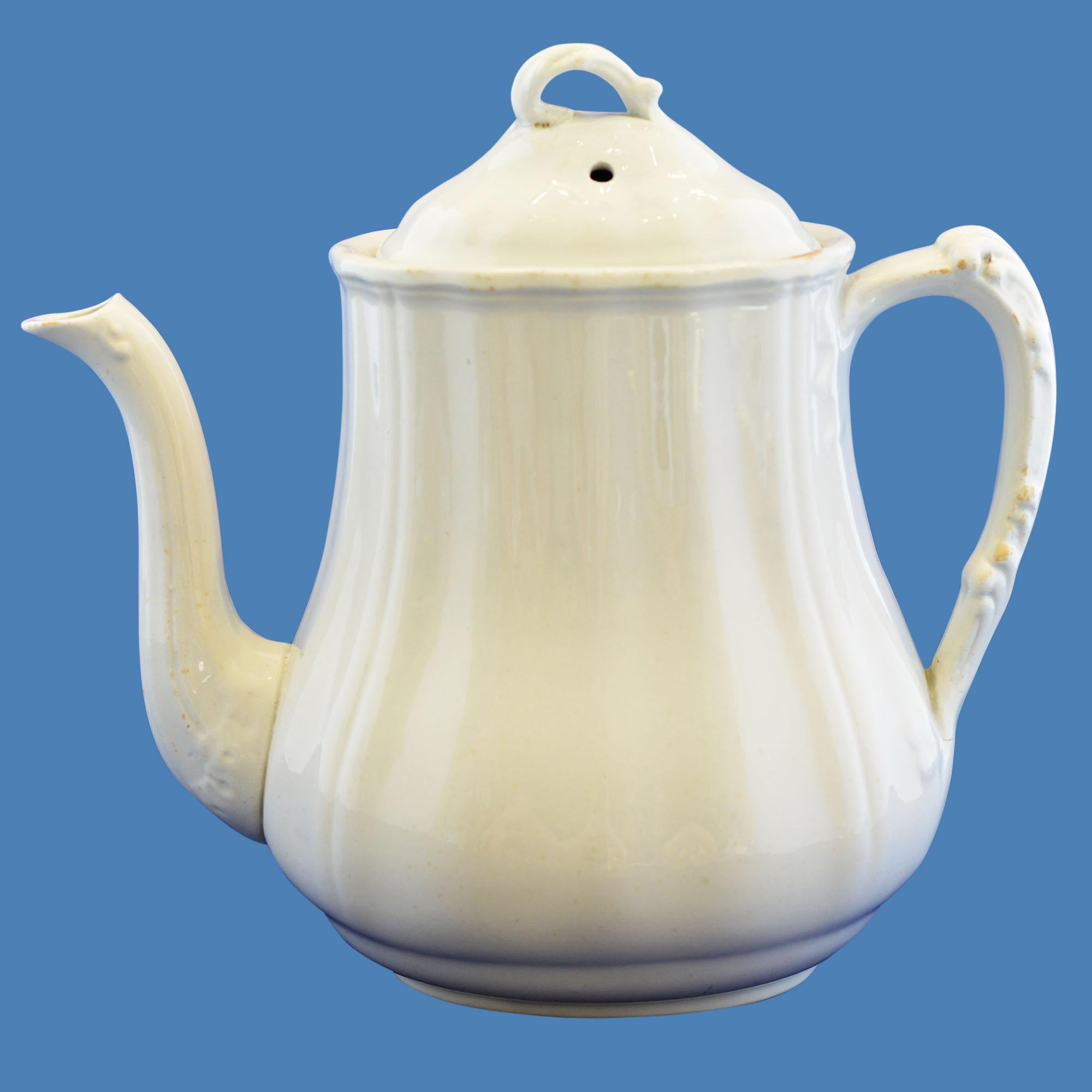 Ironstone teapot in white has maker's mark on bottom.