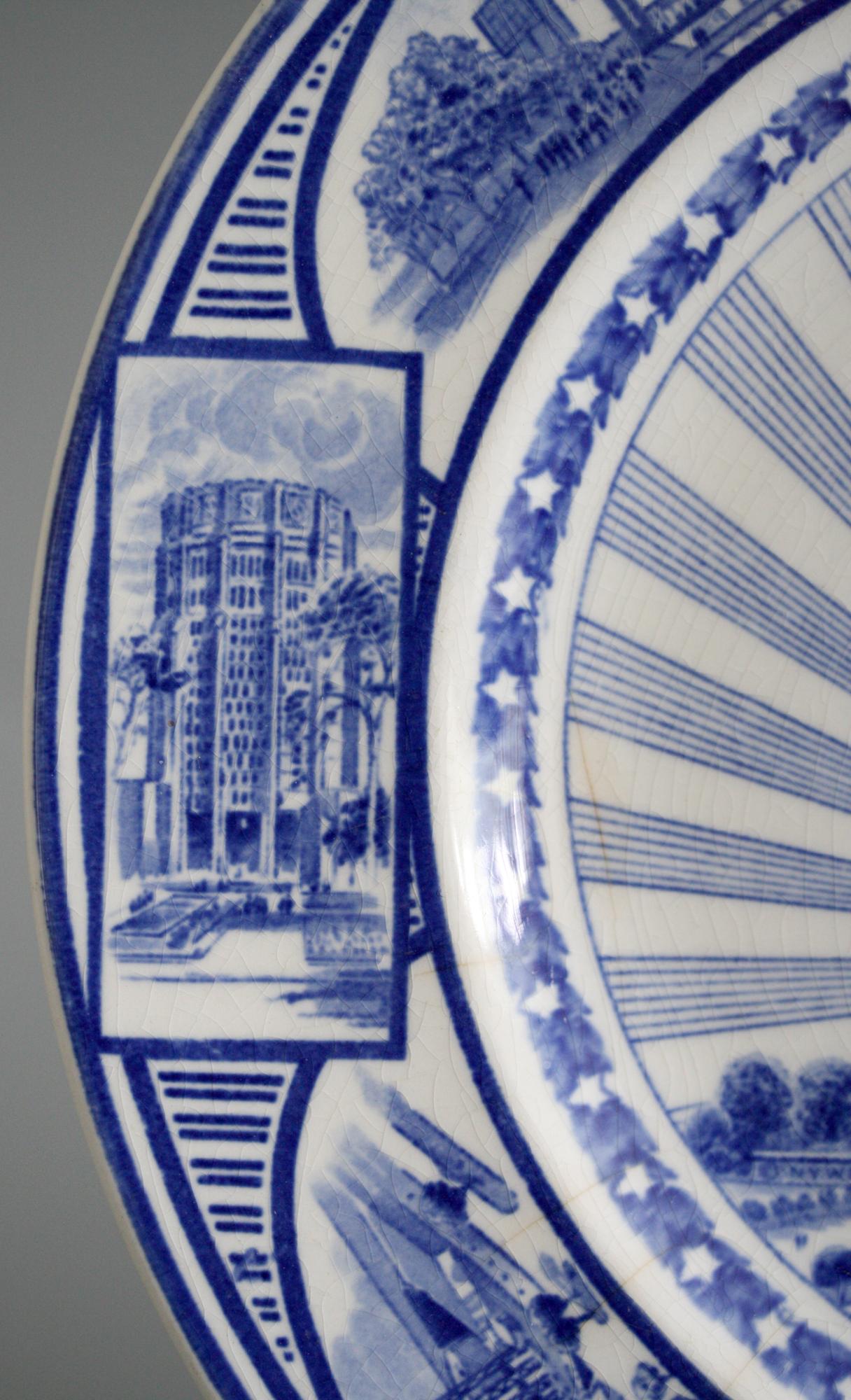 A fine English J & G Meakin commemorative pottery plate made for the New York Worlds Fair, 1789 - 1939. The plate is transfer printed in blue on a white ground and has panels containing pavilions representing various of the participating countries