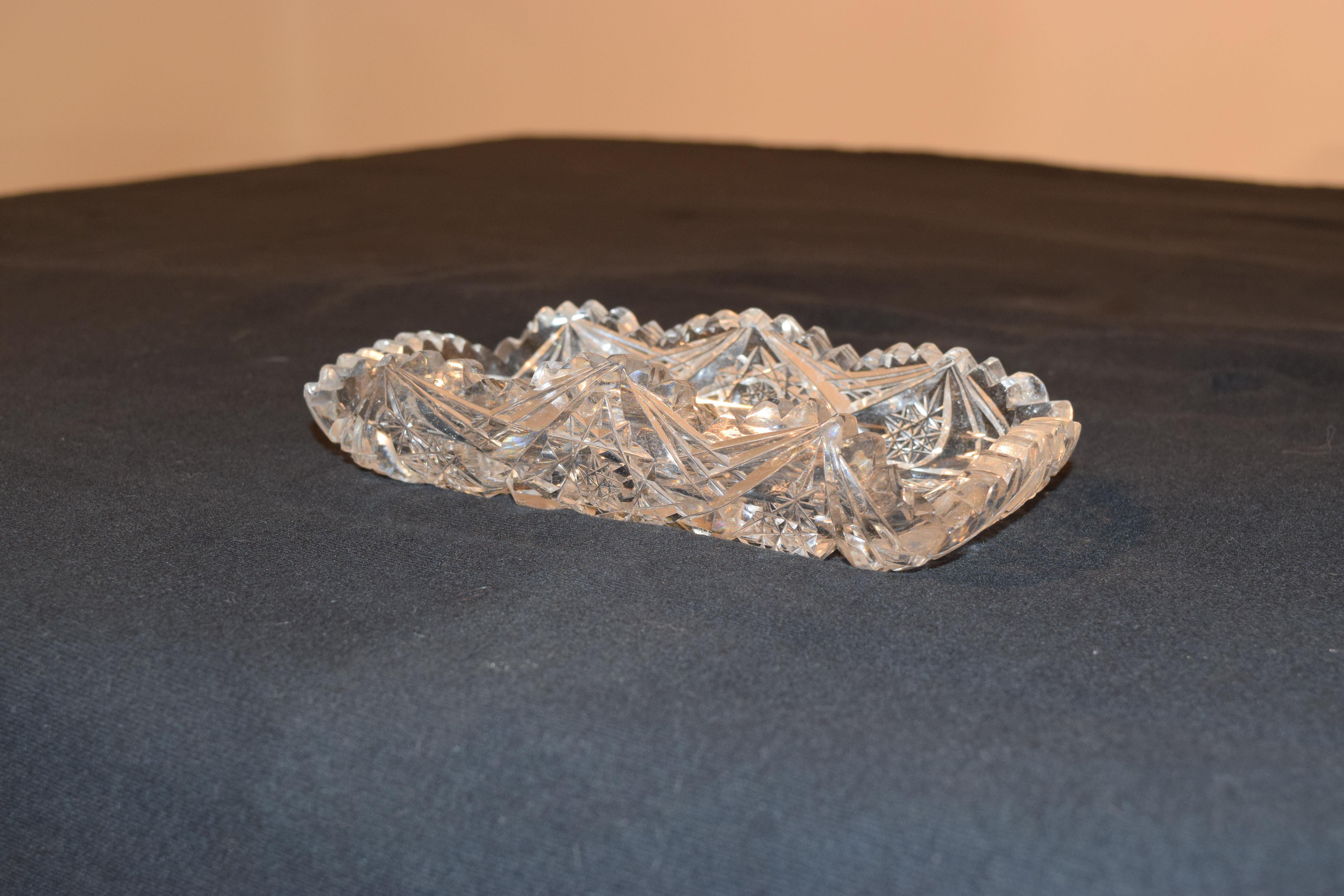 This is a gorgeous piece of American Brilliant Glass by J. Hoare. The bowl features a beautiful pattern of hobstar and cane detailing, all intersecting at the very center, as well as a sawtooth, scalloped rim. The crystal is stunning. The deep