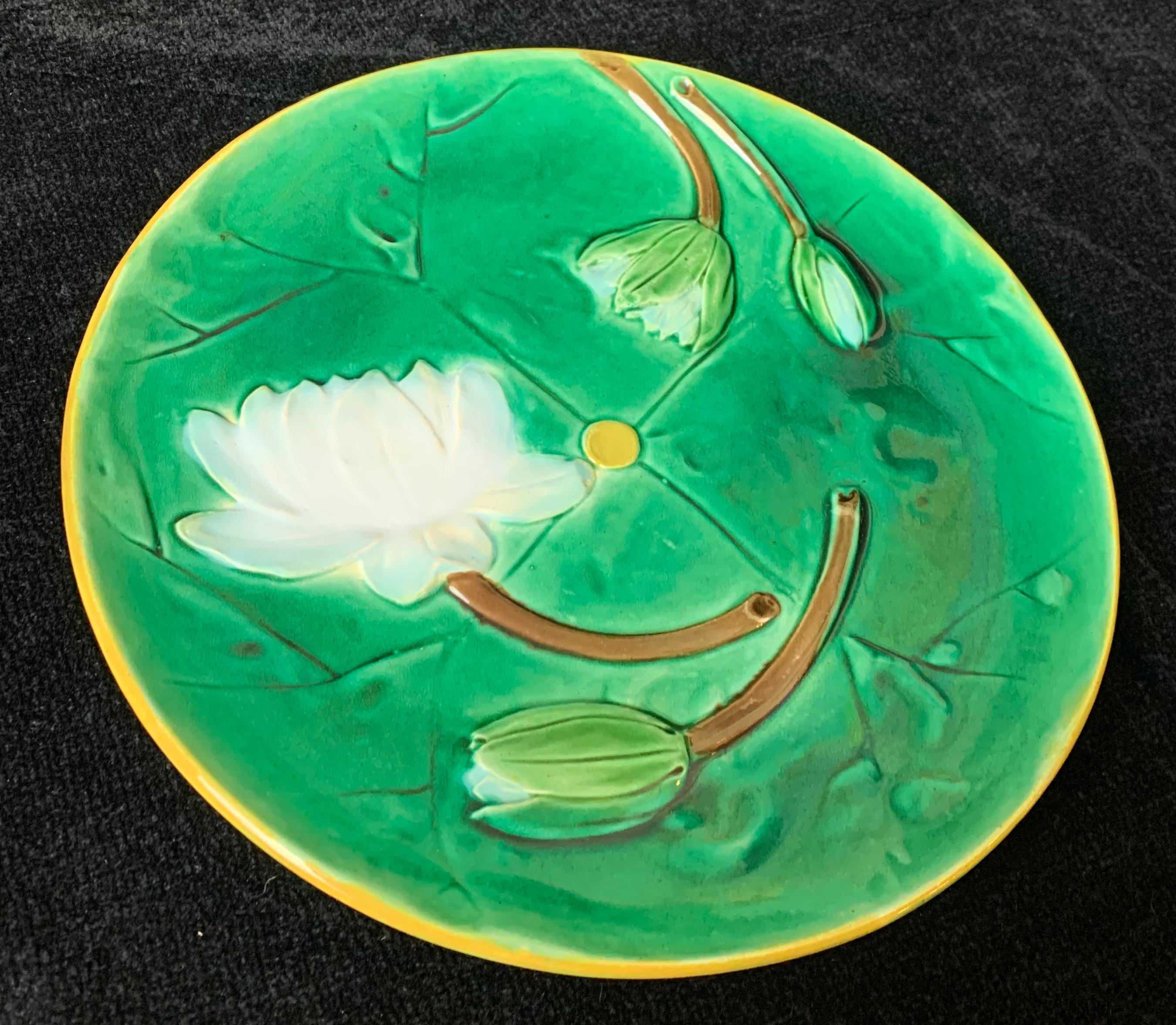 Joseph Holdcroft Majolica Pond Lily plate, English, circa 1875, Signed 'J HOLDCROFT'. Glazed in deep emarald green molded with flowering white lotuses, impressed to reverse: 'J HOLDCROFT' for Joseph Holdcroft. A signed example of this pattern is