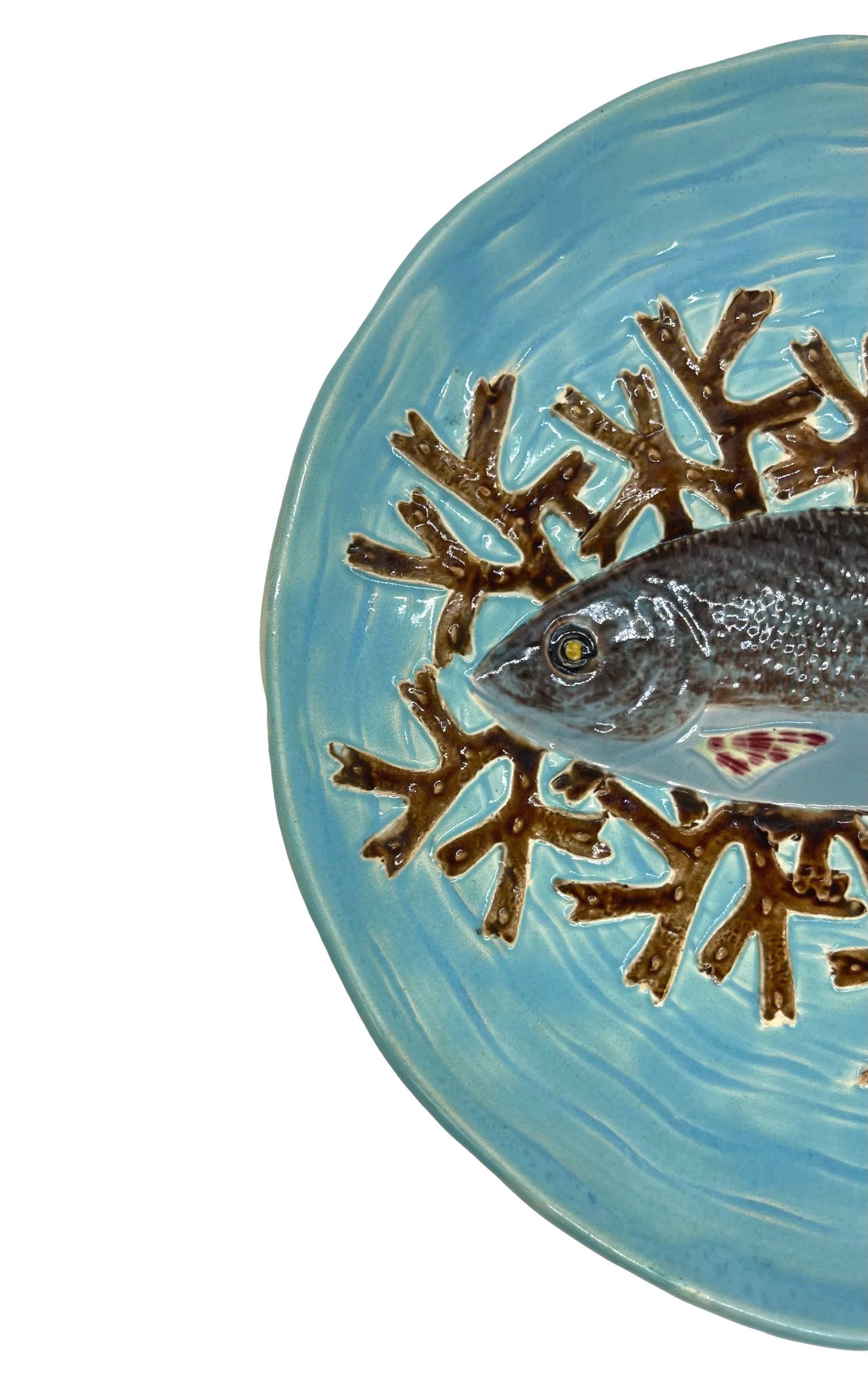 Joseph Holdcroft Majolica Trompe L'oeil salmon plate, naturalistically molded with a life-like salmon on a bed of red seaweed, on a relief molded basket-weave turquoise ground; the reverse with impressed mark,
'J HOLDCROFT.' 
For 30 years, we have