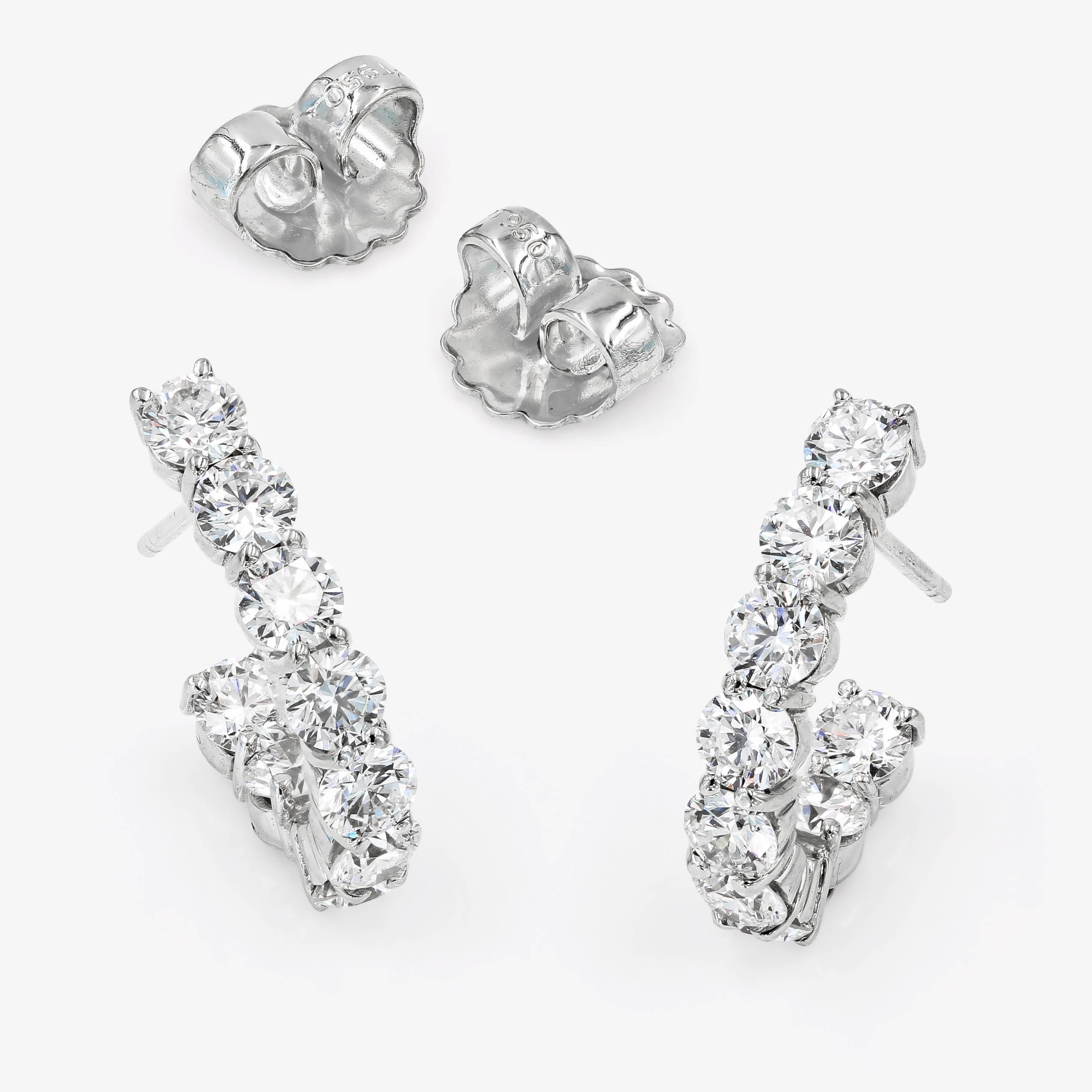 Lester Lampert original J-Hoop earrings are set with 18 ideal cut round diamonds= 3.96cts. t.w. 
(the diamonds are F/G in color and VS in clarity) in 18kt. white gold. The earrings are finished with a post and clutch back.

Every Lester Lampert