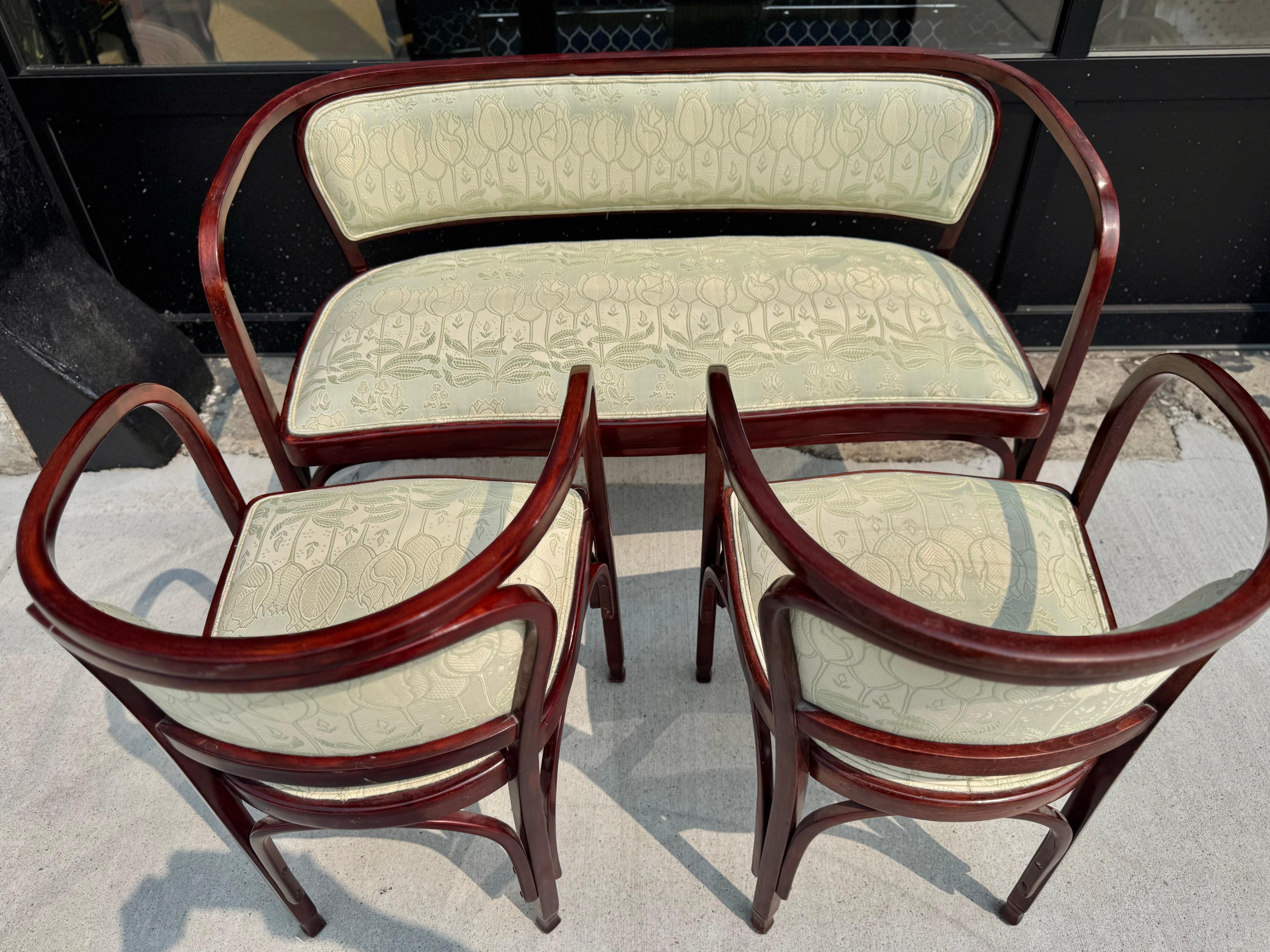 A rare and historically significant Art Nouveau settee, Model No. 715, with matching pair of arm-chairs.designed by Gustav Siegel in 1899 and produced by the renowned Viennese furniture maker Jacob & Josef Kohn. This elegant piece exemplifies the