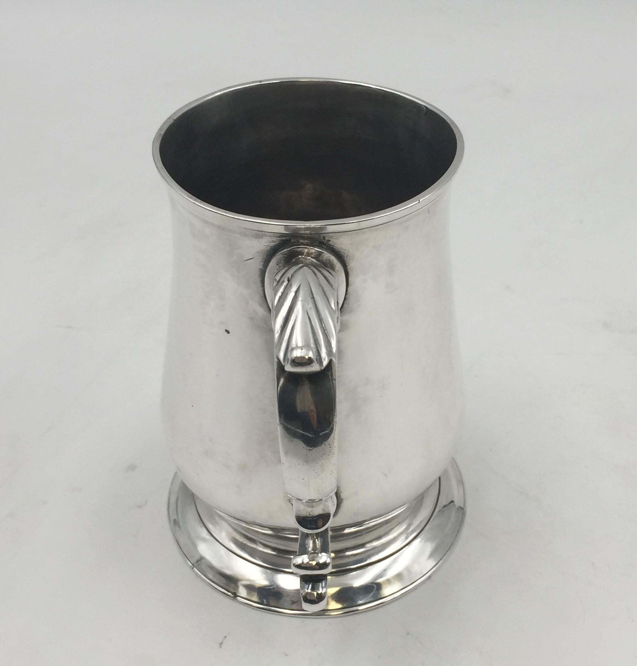 1788 sterling silver tankard mug by John Kelly, a London-based silversmith, from the Georgian era with applied decorations on the handle and in beautiful, elegant design. It measures 4 7/8'' in height by 3 1/2'' in base diameter, weighs 10 ozt, and