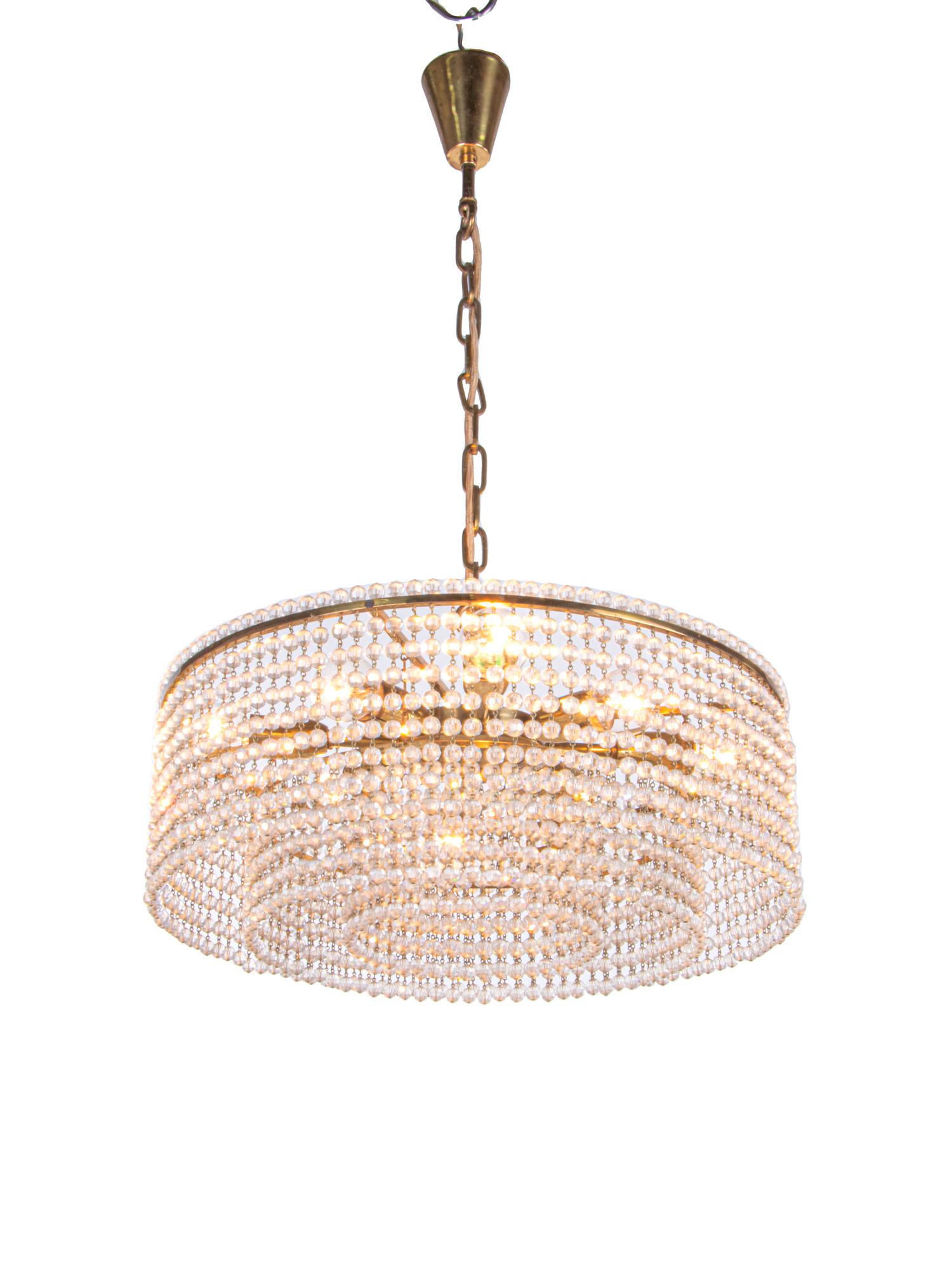 Elegant mid-century chandelier with a brass frame and sparkling hand-cut faceted crystal pearl strings. These lamps have an incomparable unique character. A touch of luxury fills the room. Manufactured by Lobmeyr, Vienna, Austria in the 1960s.