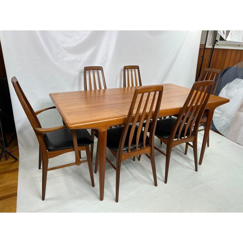 Danish J. L. Møller teak extendable dining table with 6 Niels Koefoeds dining chairs. both leaves store in one side of the table.

Chairs measure:
19” W 17.75” D 37.75” H
Seat height 18”
Captain chairs width: 21”

Table measures 63” without