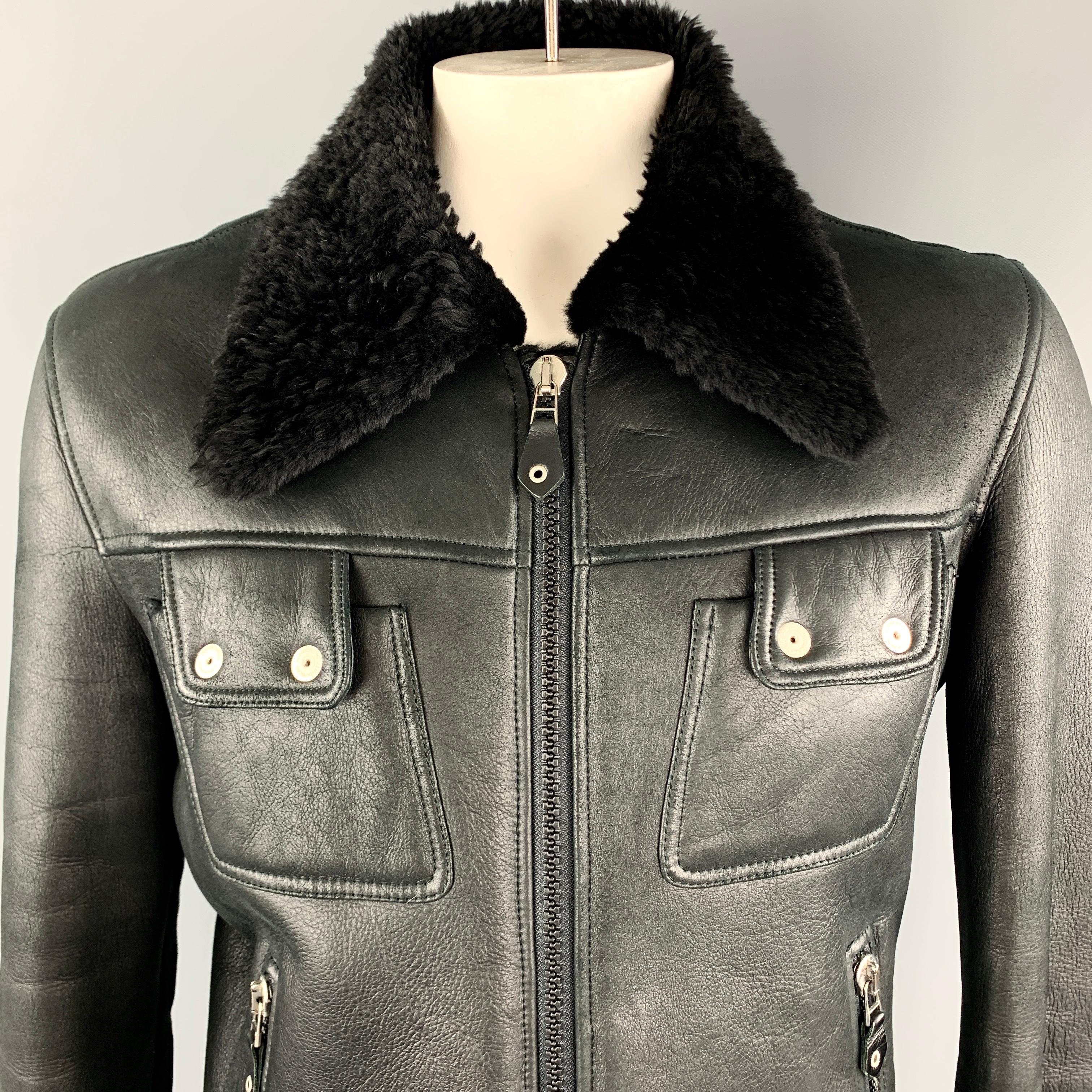 J LINDEBERG Jacket comes in a black shearling leather with a fur pointed collar, double zip front, patch snap pockets, dual slanted zip pockets zip cuffs with tab, and patchwork back.

Excellent Pre-Owned Condition.
Marked: