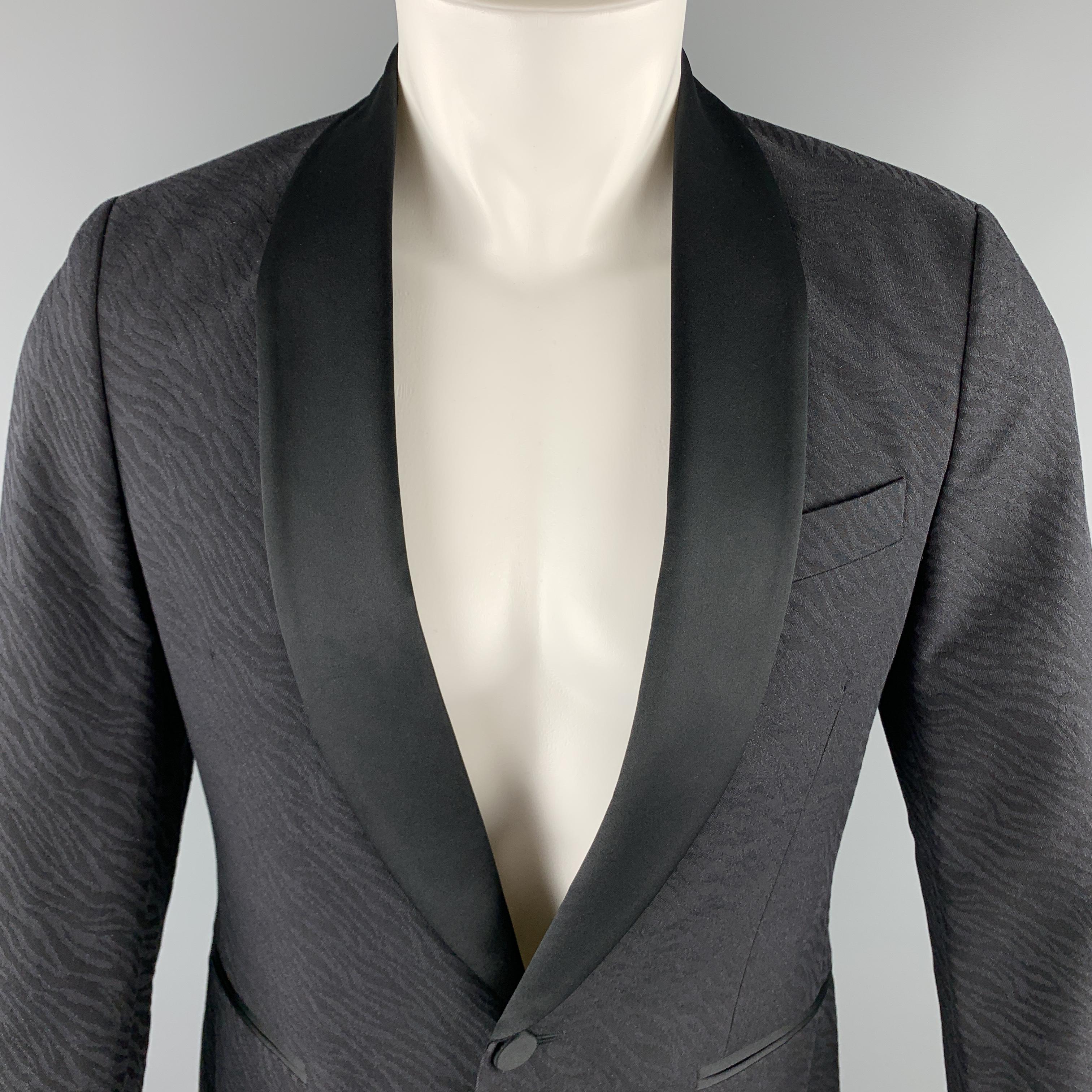 J. LINDEBERG sport coat comes in a black jacquard cotton / wool material, featuring a contrast black solid shawl collar, a single button at closure, single breasted, a single button at cuff, slit pockets, and a double vent at back. 

Excellent