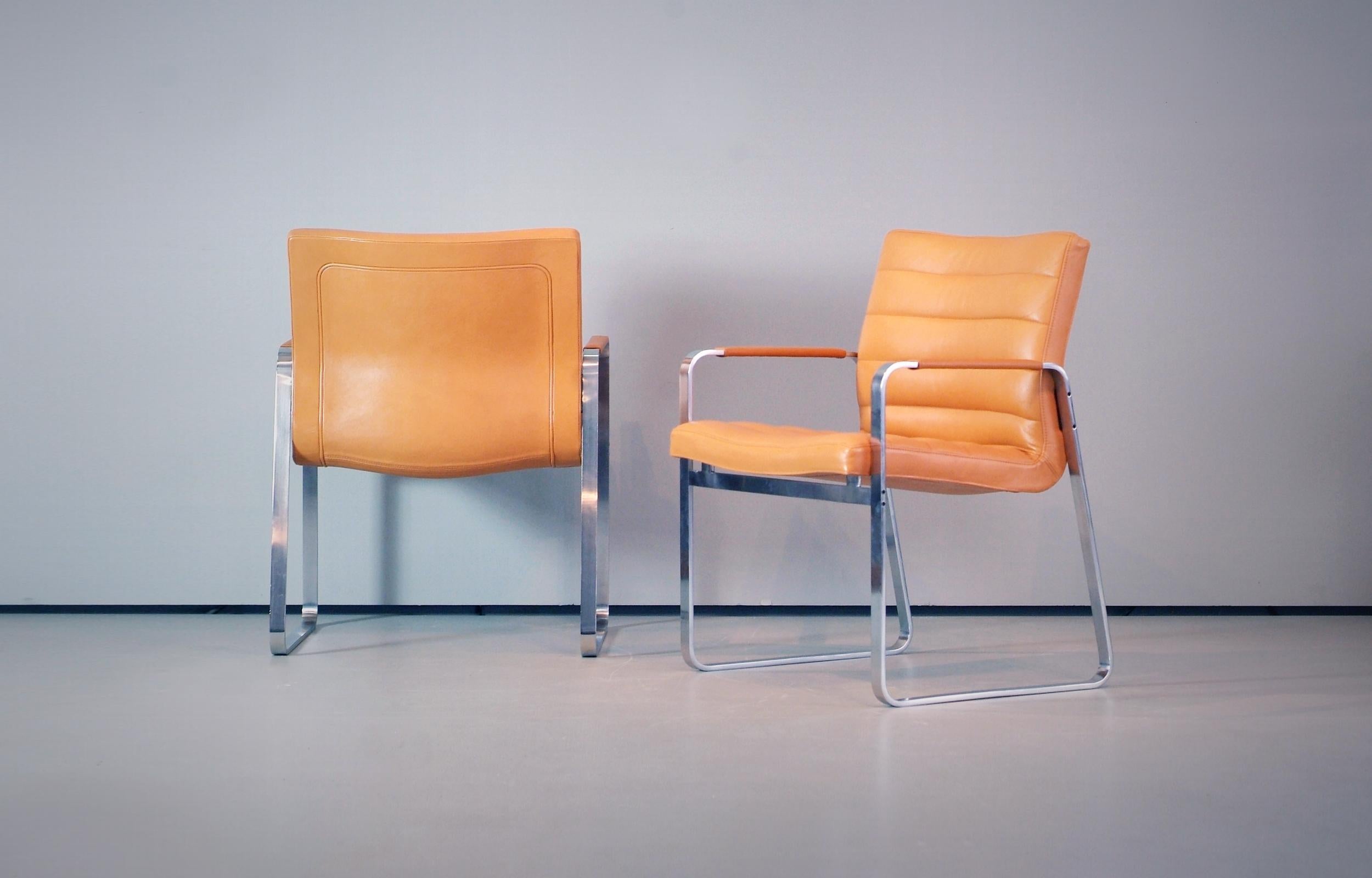 A wonderful set of chairs designed by J. Lund and O. Larsen made by BO-EX Mod. BO-850 in the late 1960s-early 1970s, original cognac / light brown leather seat / back matte chromed steel base. 

Perfect vintage condition with only minimal wear.
