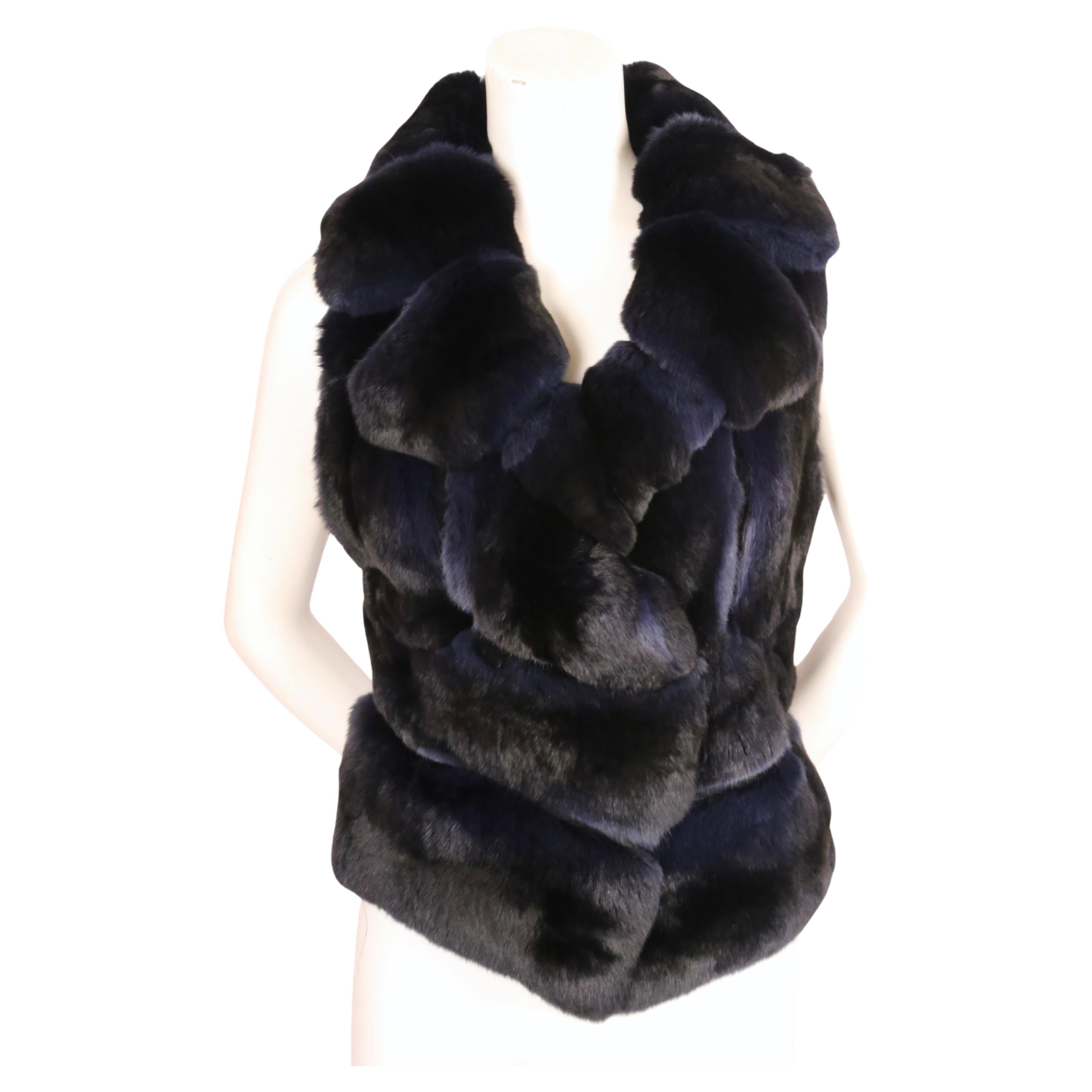 Striking blue and black dyed Chinchilla vest from J. Mendel. Very flattering seam construction and subtle ombre colorway. There is no size indicated, however this best fits a US 2-4. If the fur hook is moved, it can accommodate more sizes.