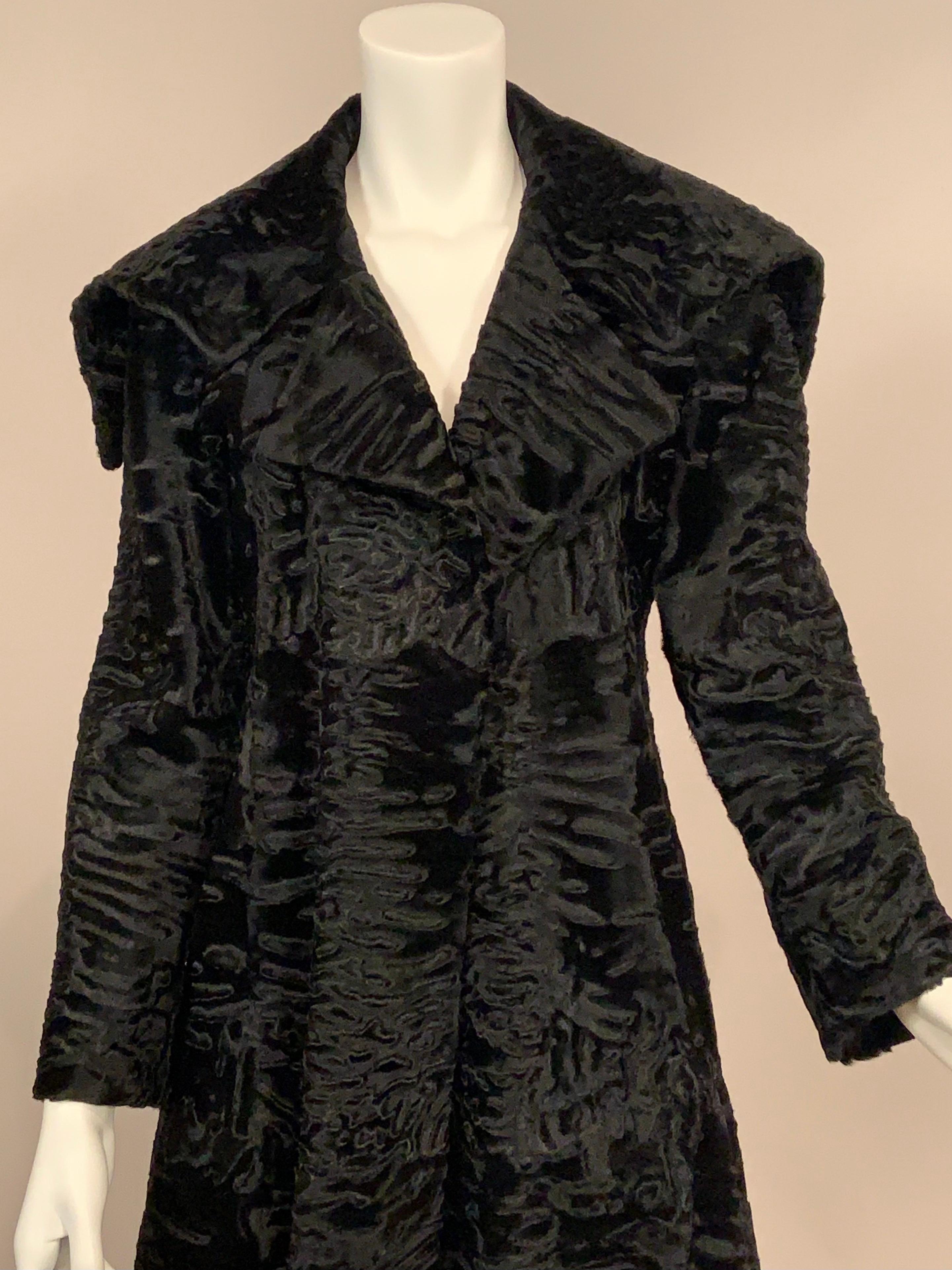 This beautiful, brand new black Swakara coat from J. Mendel, Paris has an original price tag of $23,500.00.   It feels like velvet but it will keep you much warmer.  The coat has an oversized collar which can be worn up or down for two distinctly