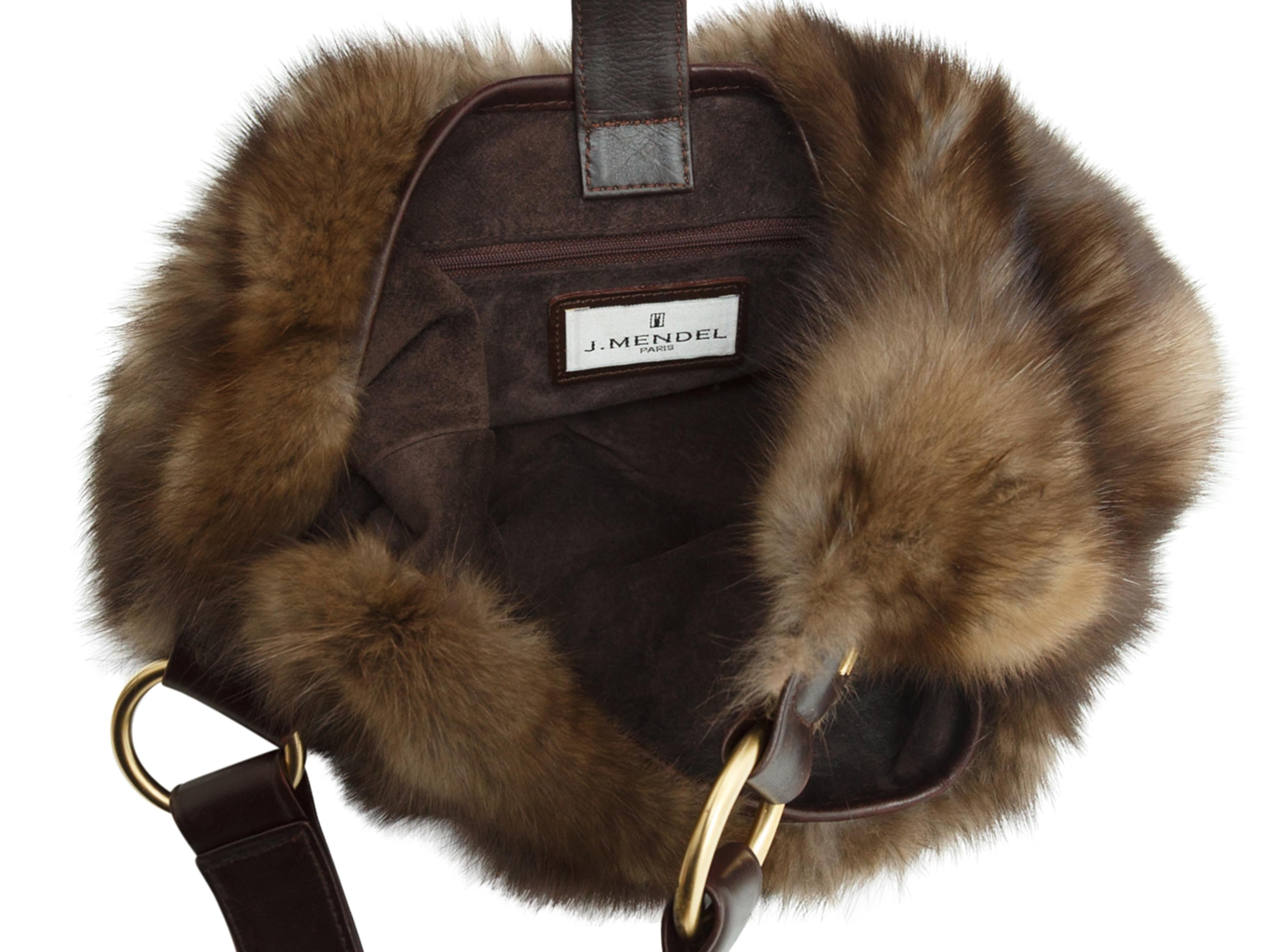 Product details: Brown sable fur shoulder bag by J. Mendel. Tonal leather strap and trim. Gold-tone hardware. Interior zip pocket. Swarovski crystal closure at front. 14'' width, 12'' length, 8'' depth, 13'' shoulder drop.
Condition: Pre-owned. Very