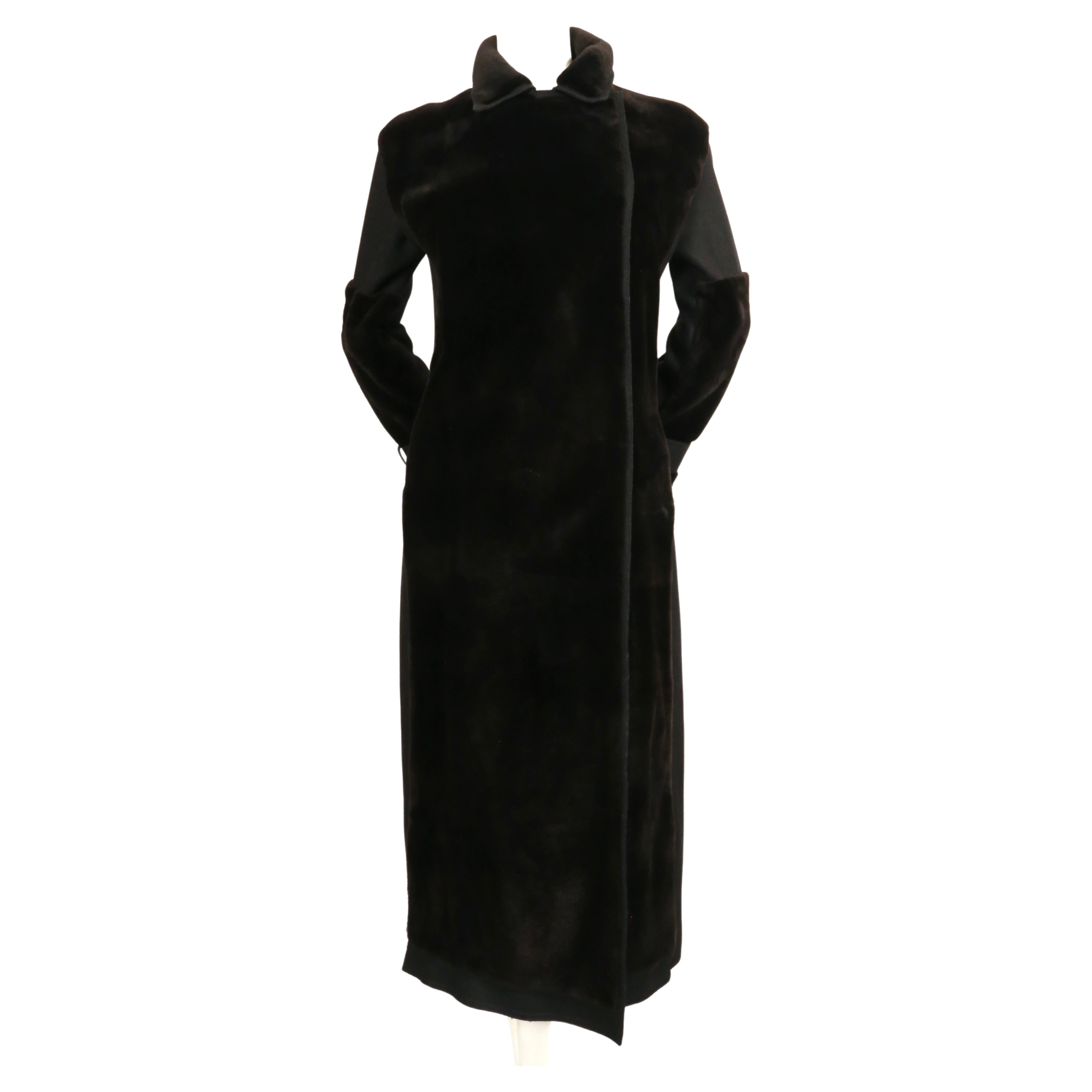 Striking dark brown mink fur coat with black felted wool panels from J. Mendel. The wool panels create a streamlined fit. There is no size is labeled but this best fits a US 2-4. Approximate measurements: shoulder 18