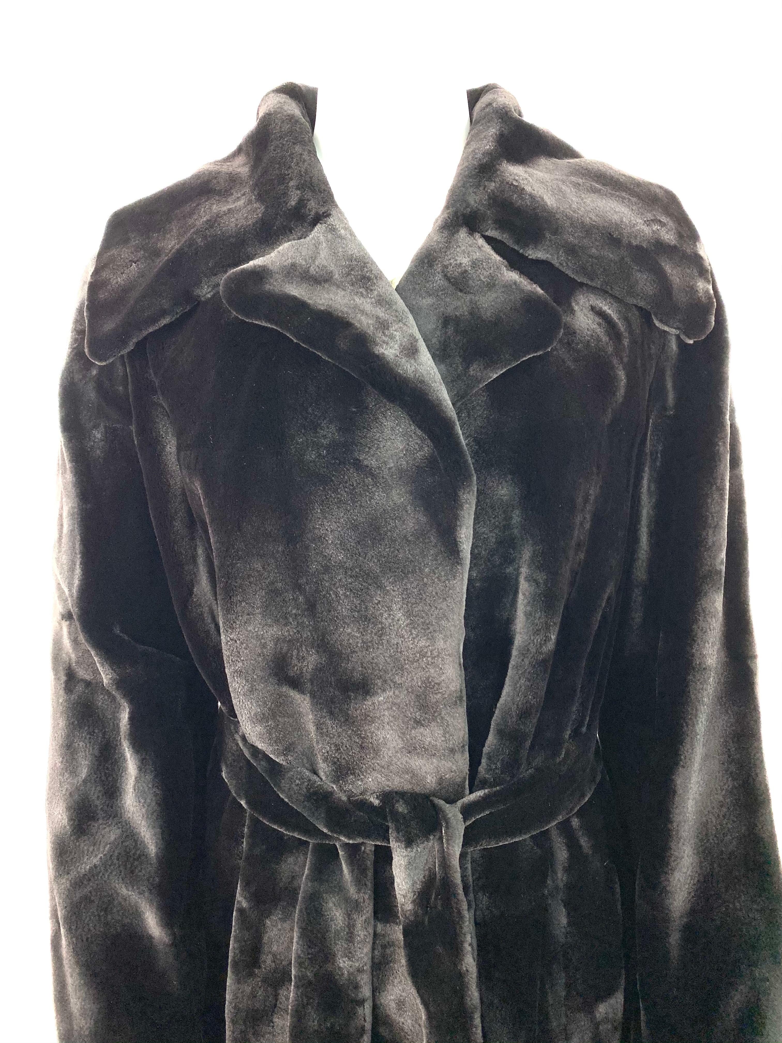 Product details:

Featuring 100% sheared mink fur and 100% double silk lining with belt closure, slit on the back (measures 18.5 inches long), collar detail and pocket on the sides, floor length. The coat fits small to large sizes. 
