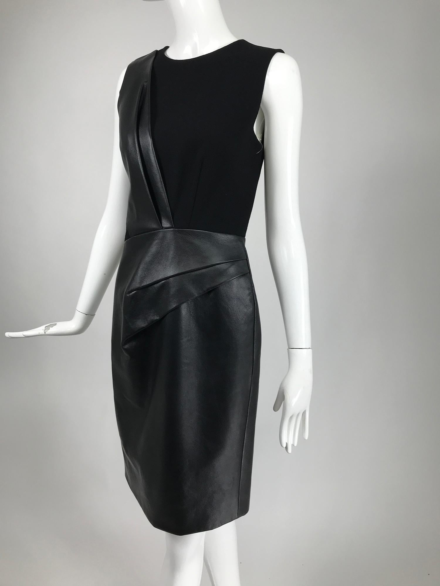 J. Mendel Paris back wool & leather sheath dress. Sleeveless, jewel neckline dress with an interesting mix of glazed black leather at the side front where it is vertically darted, the dress has an angled waist. The skirt is black leather with side