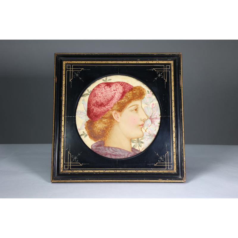 J P Hewitt. An Aesthetic Movement circular plaque painted with a Pre-Raphaelite female head set in the original incised and ebonized period frame. Signed to the back.

