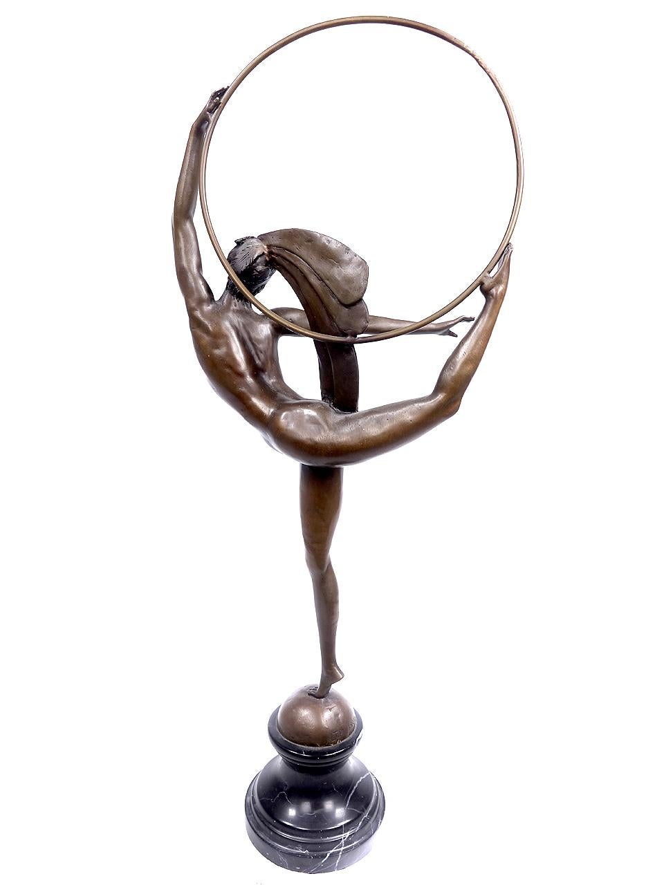 This bronze is of a highly detailed figurine, of a naked dancer, perfectly balanced on one leg, holding a hoop and with elaborate period headdress. It is signed J. P. Morante. The artist J P Morante (1882-1960) was a famous French Art Deco sculptor.