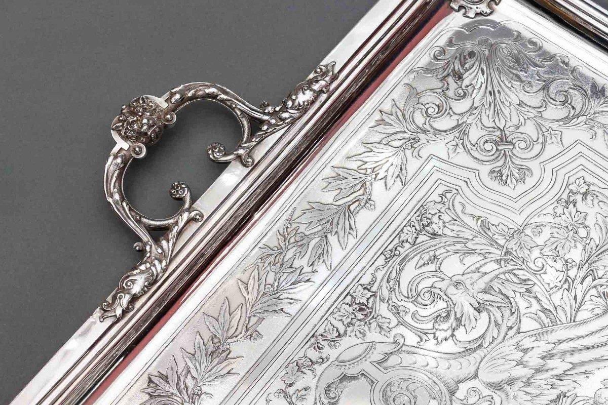 Large rectangular solid silver tray with two handles, with rich engraved and chiseled decoration on an amati background, of Renaissance inspiration, of chimeras, flowered scrolls, leafy branches, blank side cartouches, cartouches on the four corners