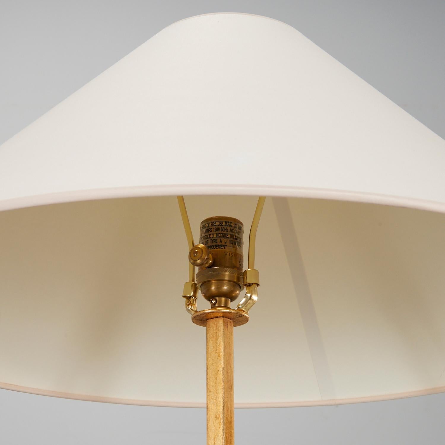 21st c., Lancaster floor lamp in iron with hand applied gilded finish and natural paper shade, marked 