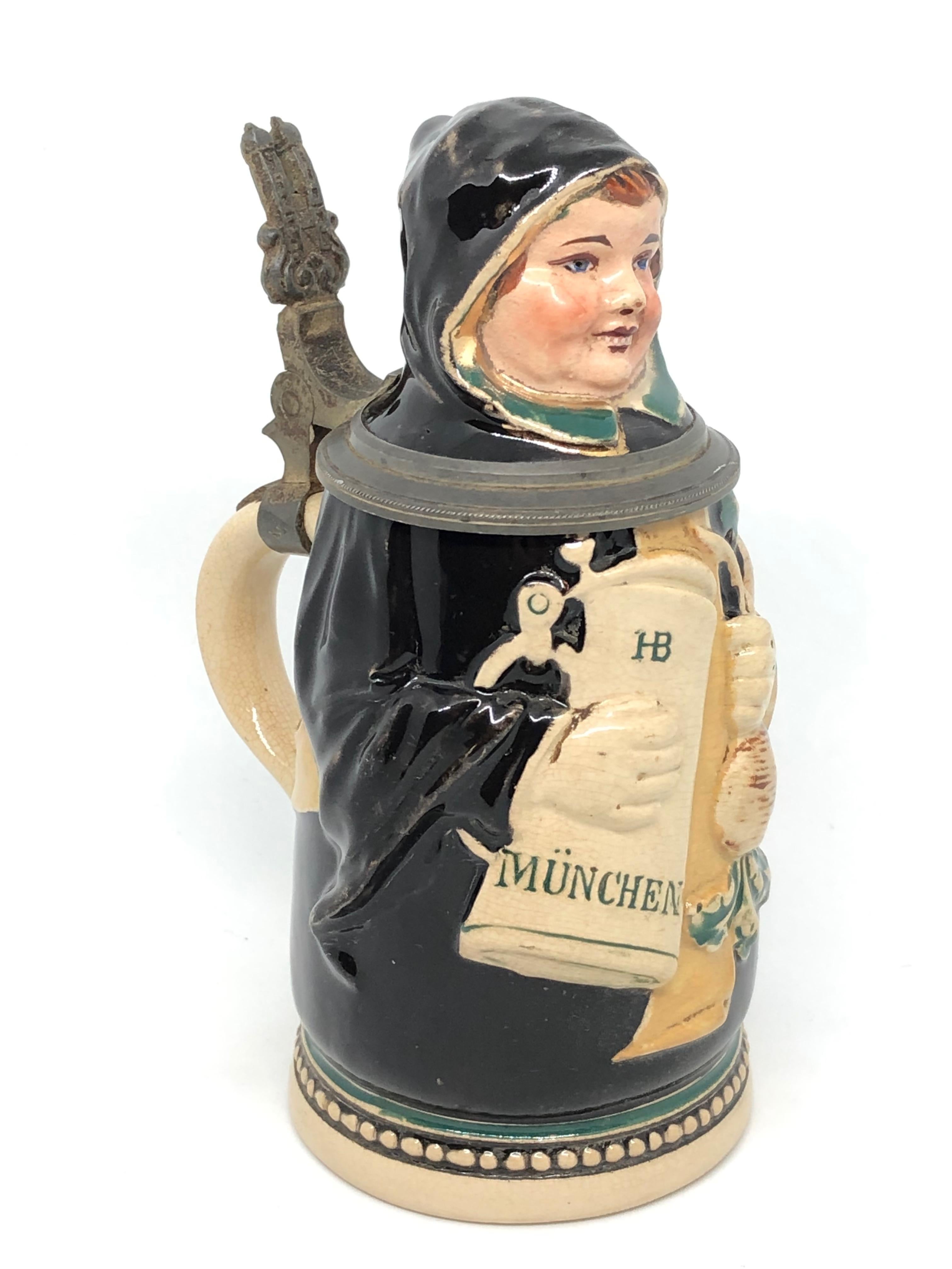 A gorgeous Character Beer Stein - Munich Child. This character beer stein has been made in Germany circa 1900s by J. Reinemann Munich. Absolutely gorgeous piece hand painted and still in great condition, without damage. Lid works properly. Marked