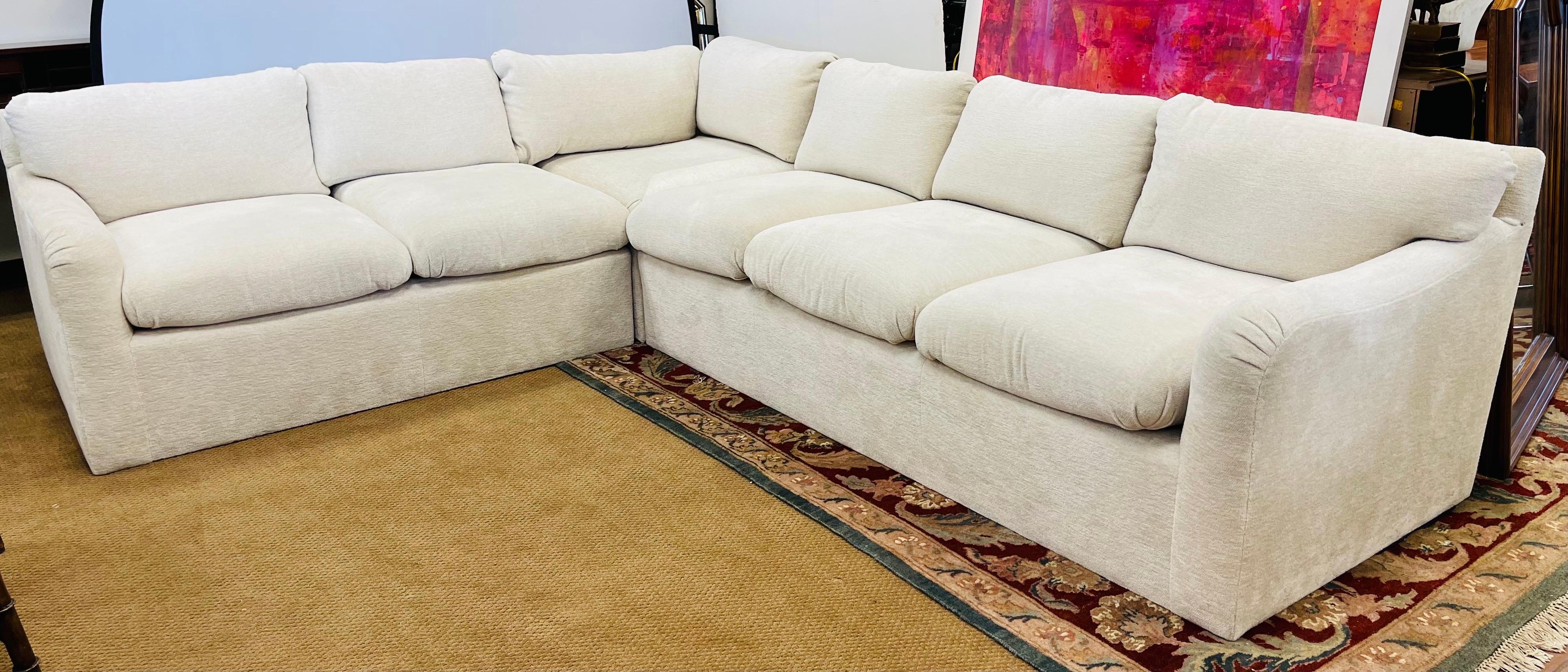 

This J. Robert Scott custom sectional sofa is a masterpiece of mid-century modern design. With seating capacity for more than six people, this oatmeal-colored chenille upholstered sofa is a perfect addition to any New York-themed home. Measuring