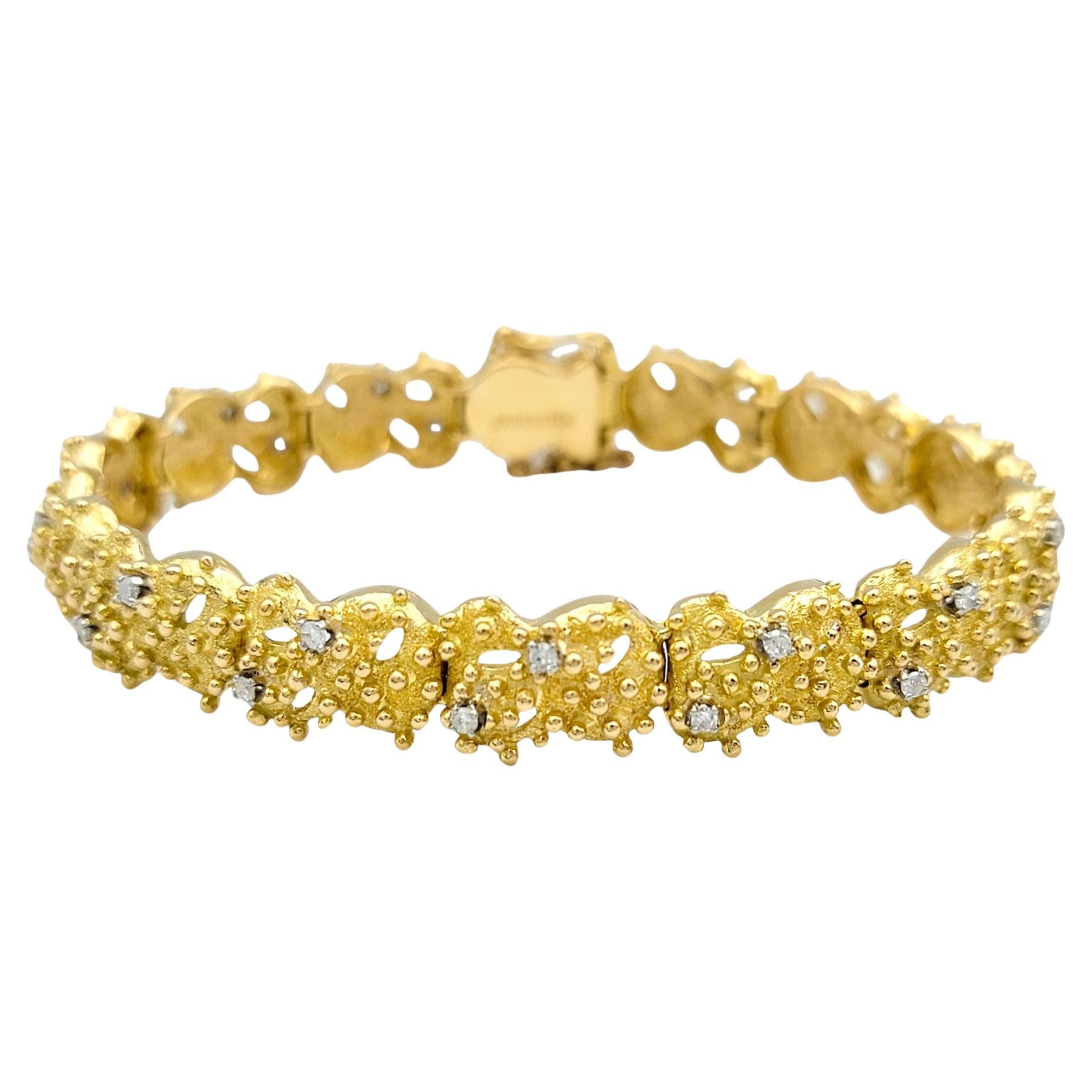 This beautiful J Rossi bracelet is a stunning work of art, blending the richness of 18 karat yellow gold with the timeless beauty of diamonds. Each link of the bracelet is meticulously crafted with an intricate granulated detailing. The tactile
