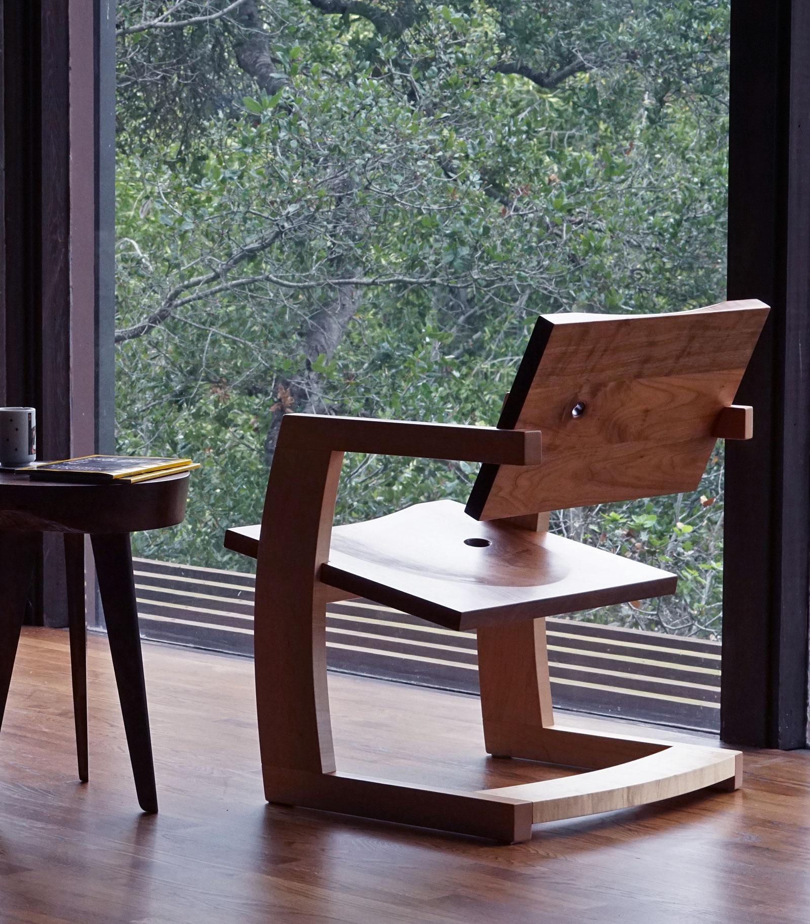 The Palo Alto chair features two contoured walnut planes that intersect a rigid maple frame. The angles of the cantilevered seat and back offer a perfect reclining position for reading, socializing, or simply contemplating the smoothness of the