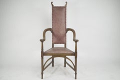 J S Henry. An ash Arts & Crafts armchair with an elongated back & curled ears