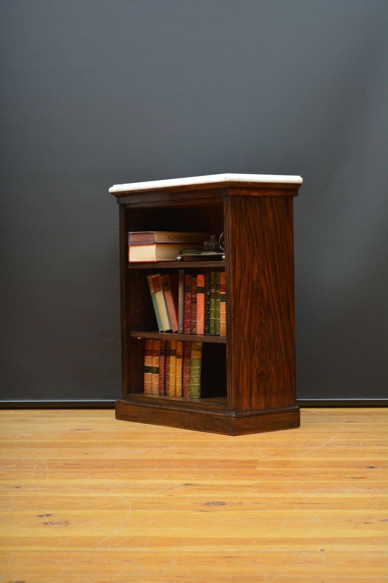 K0631 James Shoolbred, London solid mahogany with faux rosewood finish open bookcase, having original veined white marble top with  moulded edge above a shallow frieze and two height adjustable shelves with carved fronts, all flanked by fluted