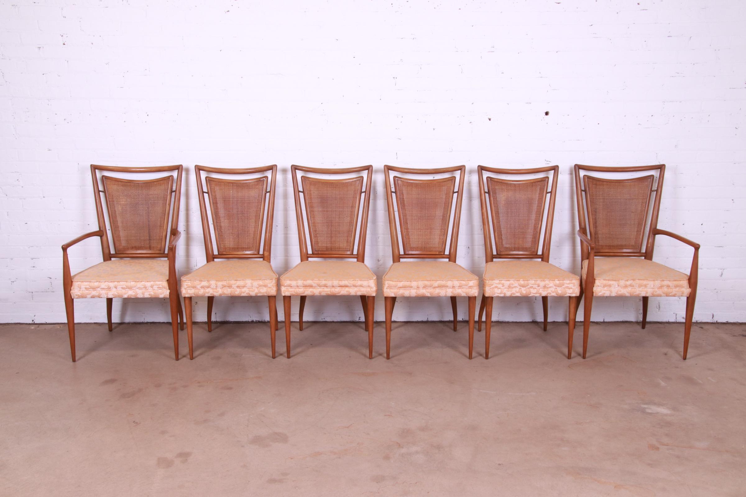 A gorgeous set of six Mid-Century Modern dining chairs

By J. Stuart Clingman for John Widdicomb

USA, 1950s

Carved solid walnut frames, with woven rattan backs, upholstered seats, and brass accents.

Measures:
Side chairs - 20