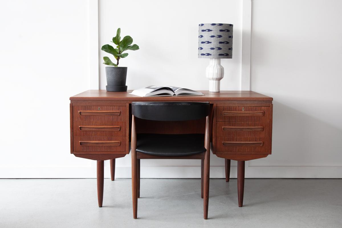 A handsome executive desk by J. Svenstrup for A.P. Møbler Denmark in teak, featuring six drawers to the front, as well as a pull down cabinet and storage space for books to the rear.

