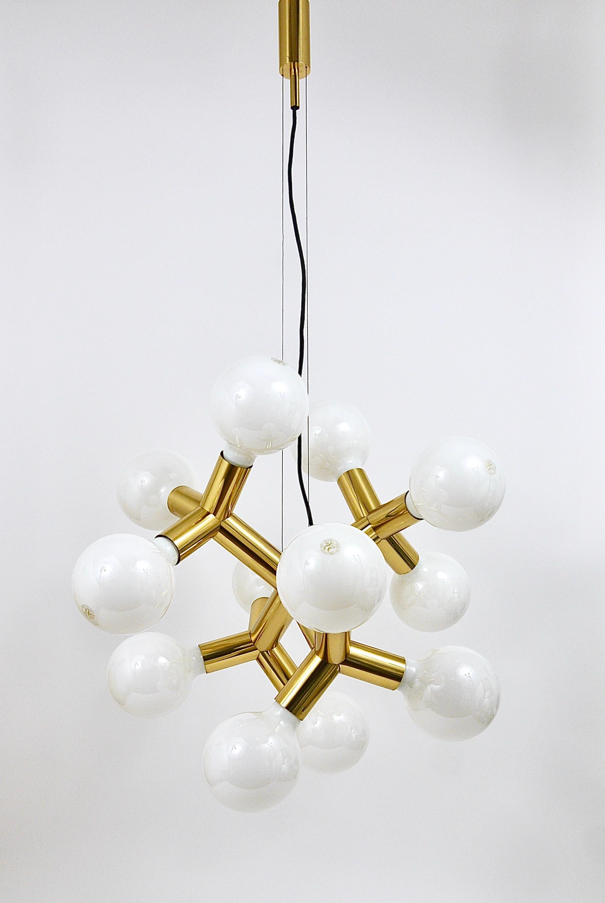 A stunning Midcentury sputnik pendant light from the late 1960s, designed and executed by Kalmar Austria. An impressive piece, made of brass, in very good condition. This sculptural chandelier offers 12 light sources and looks great from all angles