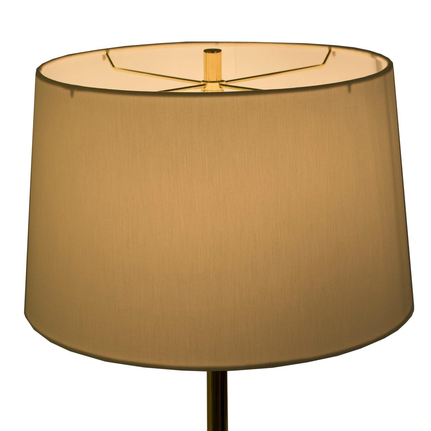 Circa 1980's tripod base floor lamp. Sleek design replated with brass base and stem. An elegant example of European Post Modern design. Sourced through from a New York collector.