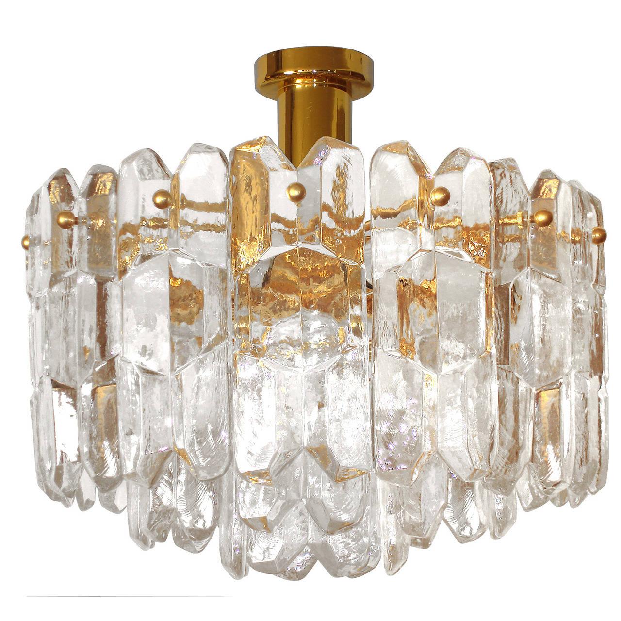 A chandelier consisting of multiple pieces of glass hung from a brass frame with brass hardware by J. T. Kalmar.

Austrian, Circa 1960's 

Four (4) Available.