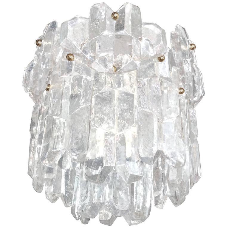 A chandelier with thick textured icy clear glass hung on a frame with base hardware by J. T. Kalmar.

Austrian, Circa 1960's

Three Chandeliers Available.