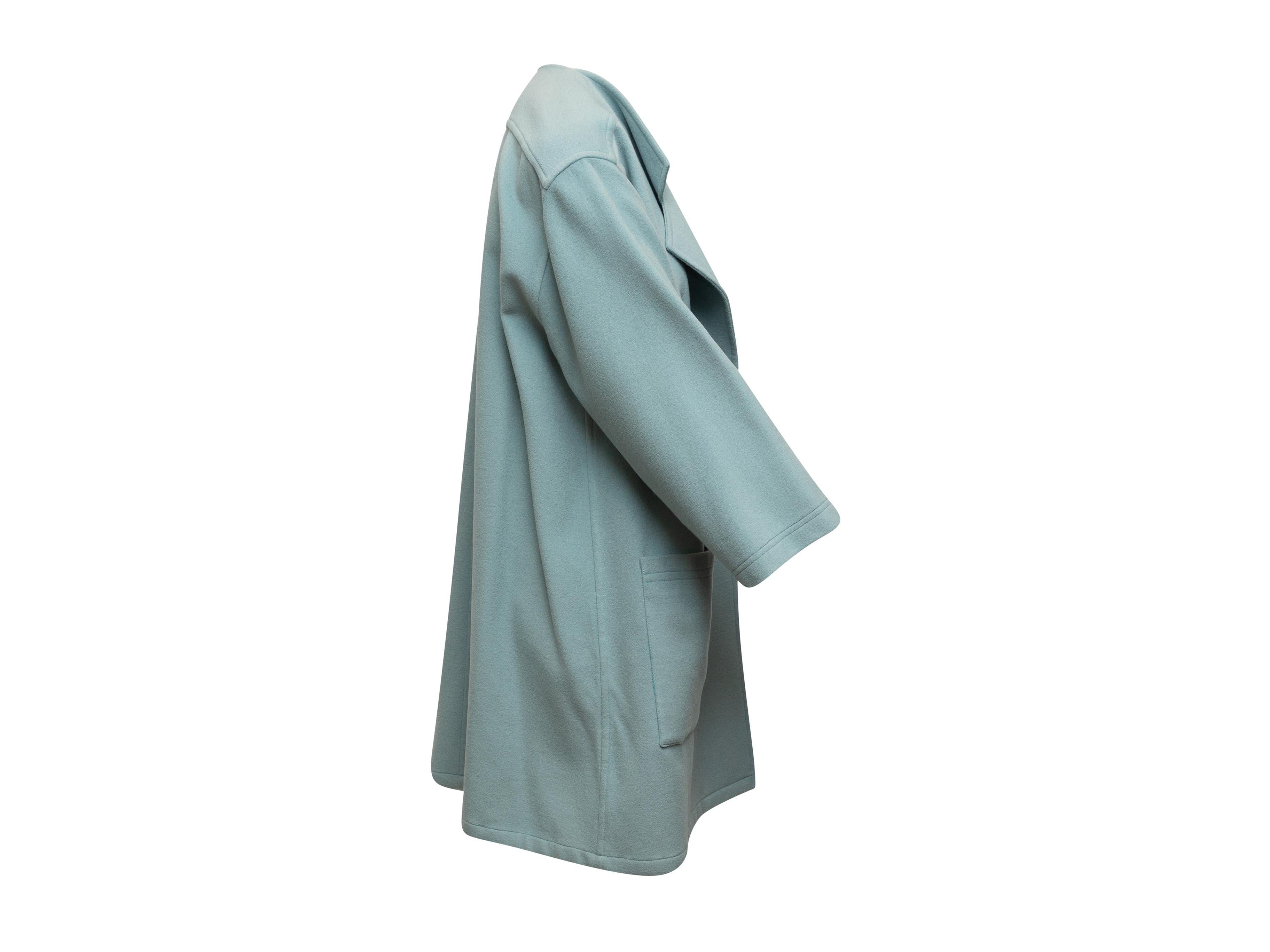 Product details: Vintage light blue wool coat by J. Tiktiner. Notched lapel. Dual patch pockets. Open front. 44