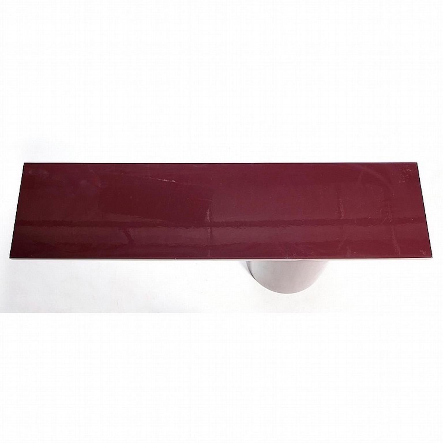 A plum lacquered asymmetric tee cantilevered console table attributed to J. Wade Beam for Brueton, circa 1980s.
Cylindrical weighted base flows and interlocks seamlessly with a half cylinder horizontal top.
Original finish is high gloss lacquered
