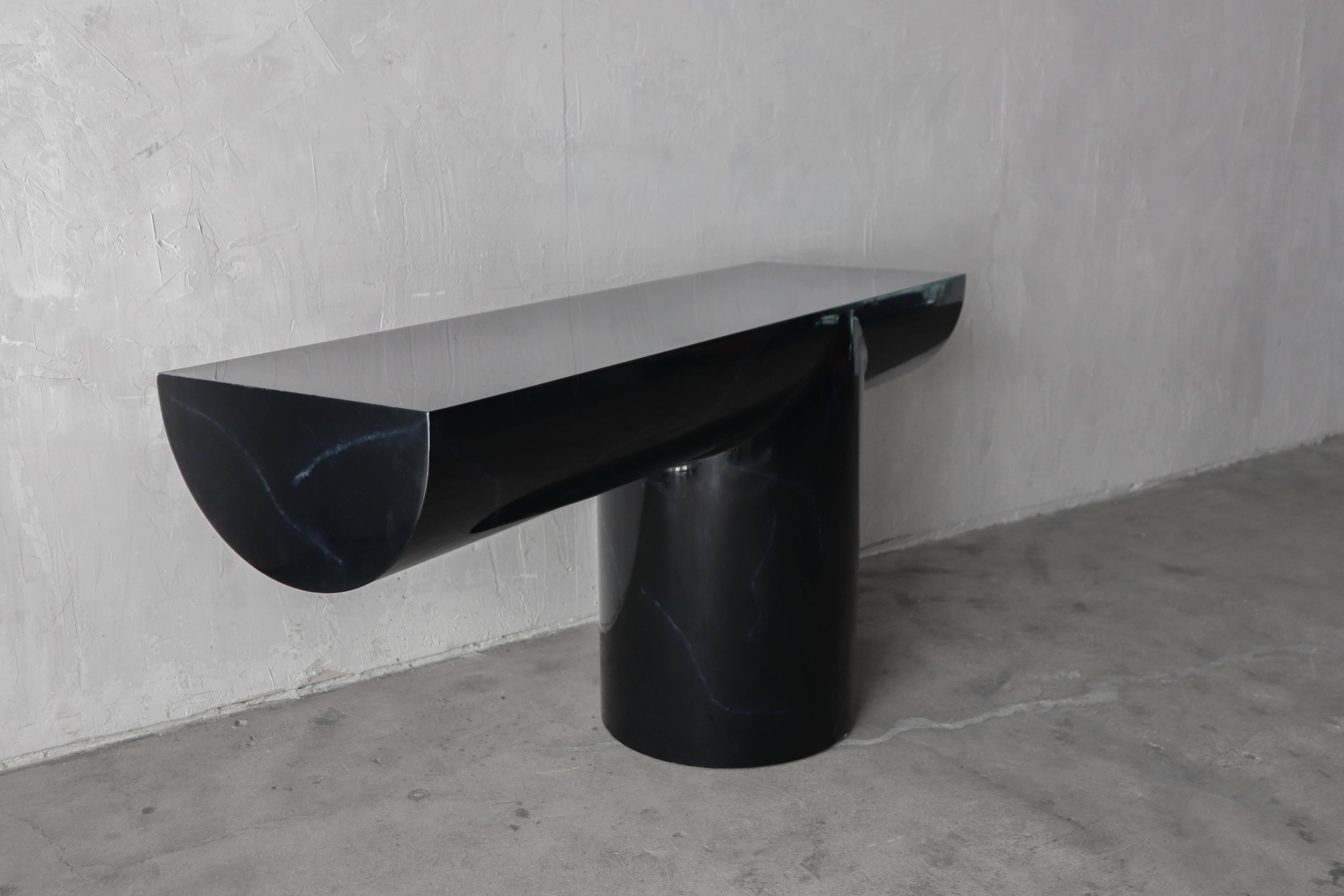 Beautiful, Tee console by J. Wade Beam for Breuton International.   This cantilevered modern console table is piano black with a few gray marble looking veins.  A big statements

The piece is lacquered and is in good condition overall.  It does show