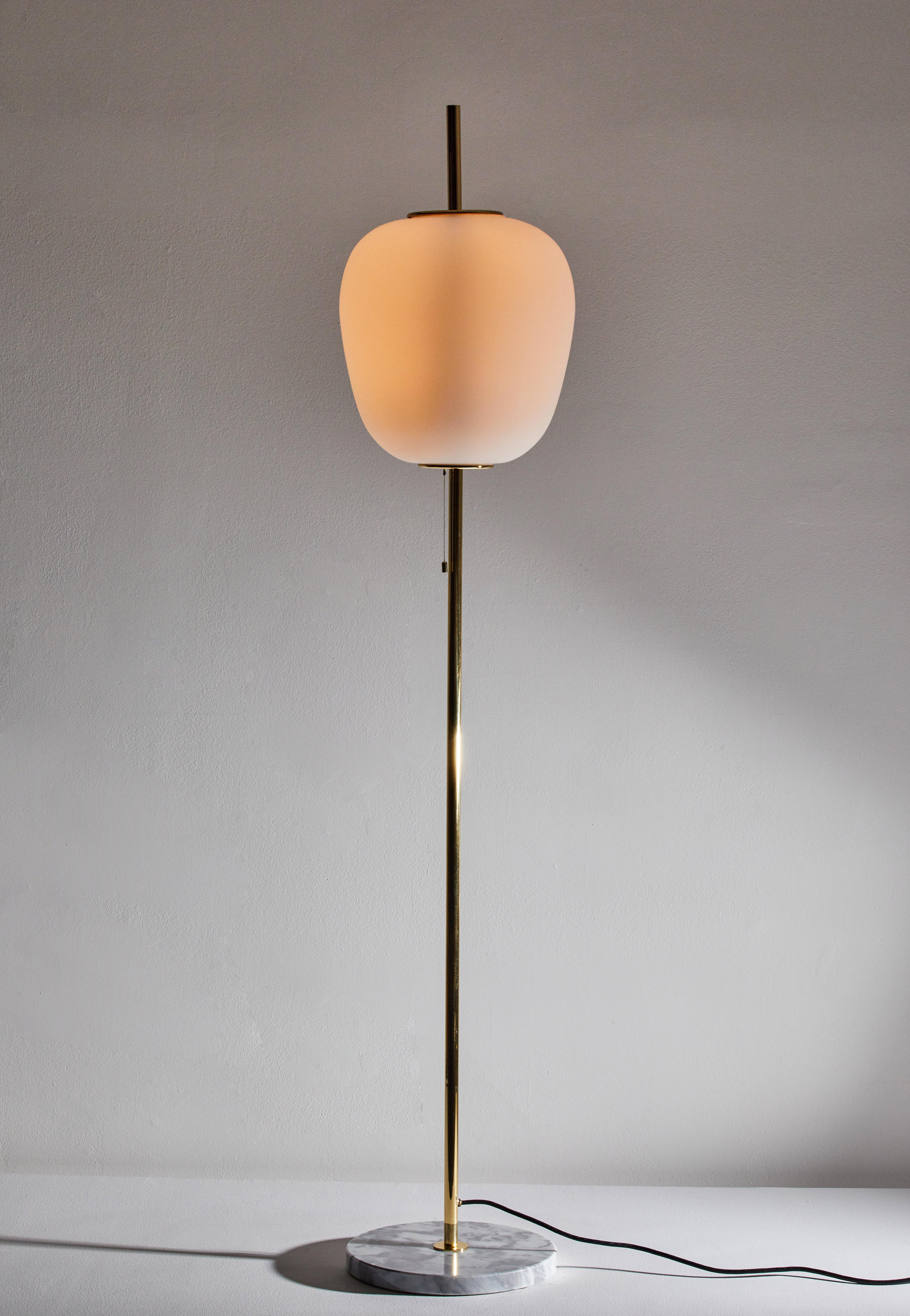 J14 floor lamp by Joseph-André Motte. Licensed, current production manufactured in France by Disderot. Brushed satin glass diffuser, brass stem with marble base. Numbered edition, delivered with authentication certificate. Wired for US. Takes one