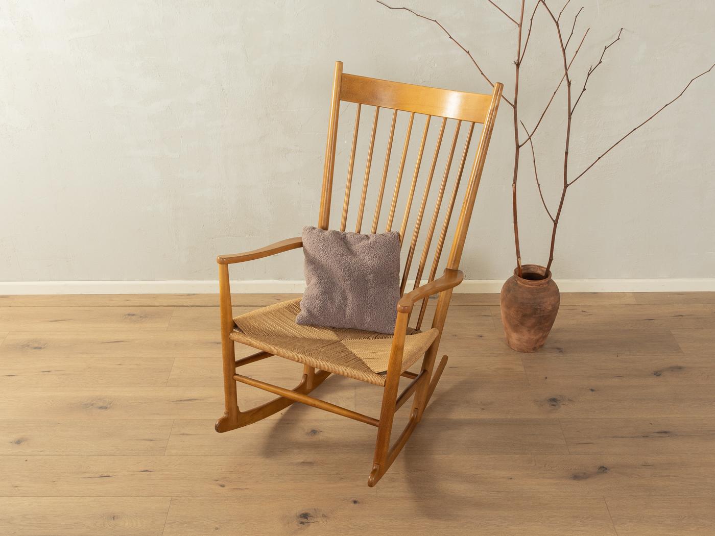 J16 rocking chair by Hans J. Wegner for Fredericia from the 1940s. High-quality solid frame made of stained beech wood with hand-woven seat made of paper yarn.

Quality Features:

accomplished design: perfect proportions and visible attention to
