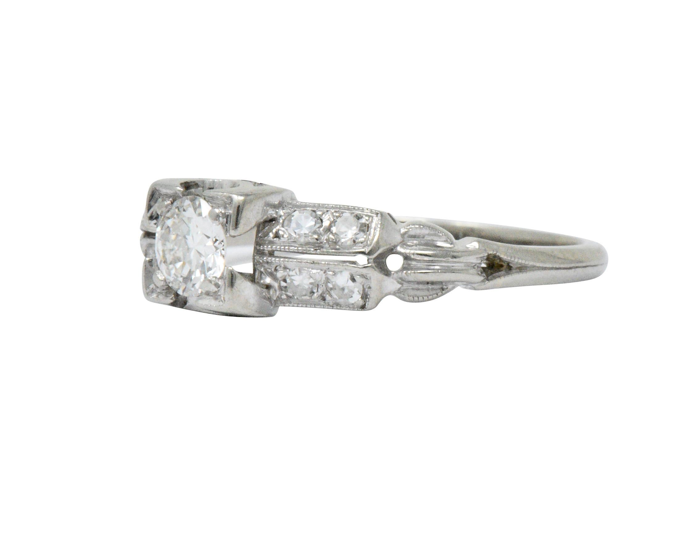 Featuring a square form head centering a round brilliant cut diamond weighing approximately 0.25 carat, H color with VS clarity

Flanked by two rows of single cut diamonds weighing approximately 0.15 carat, eye-clean and white

Completed by milgrain