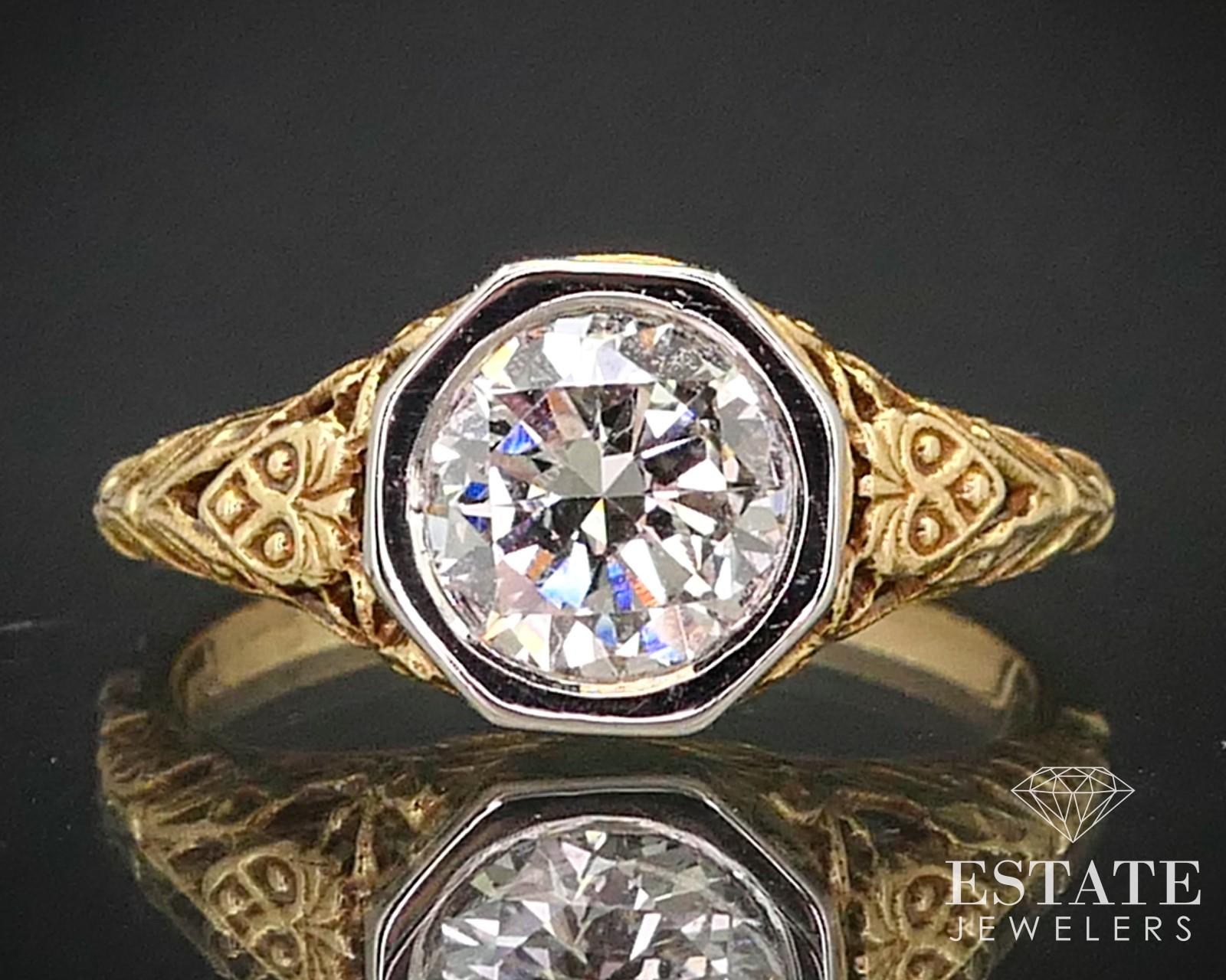 This stunning ring is a designer piece by Jabel, an American fine jewelry designer specializing in antique-style jewelry. This die struck ring is cast in 18K yellow gold with beautiful filigree design work, with an 18K white gold head - A design