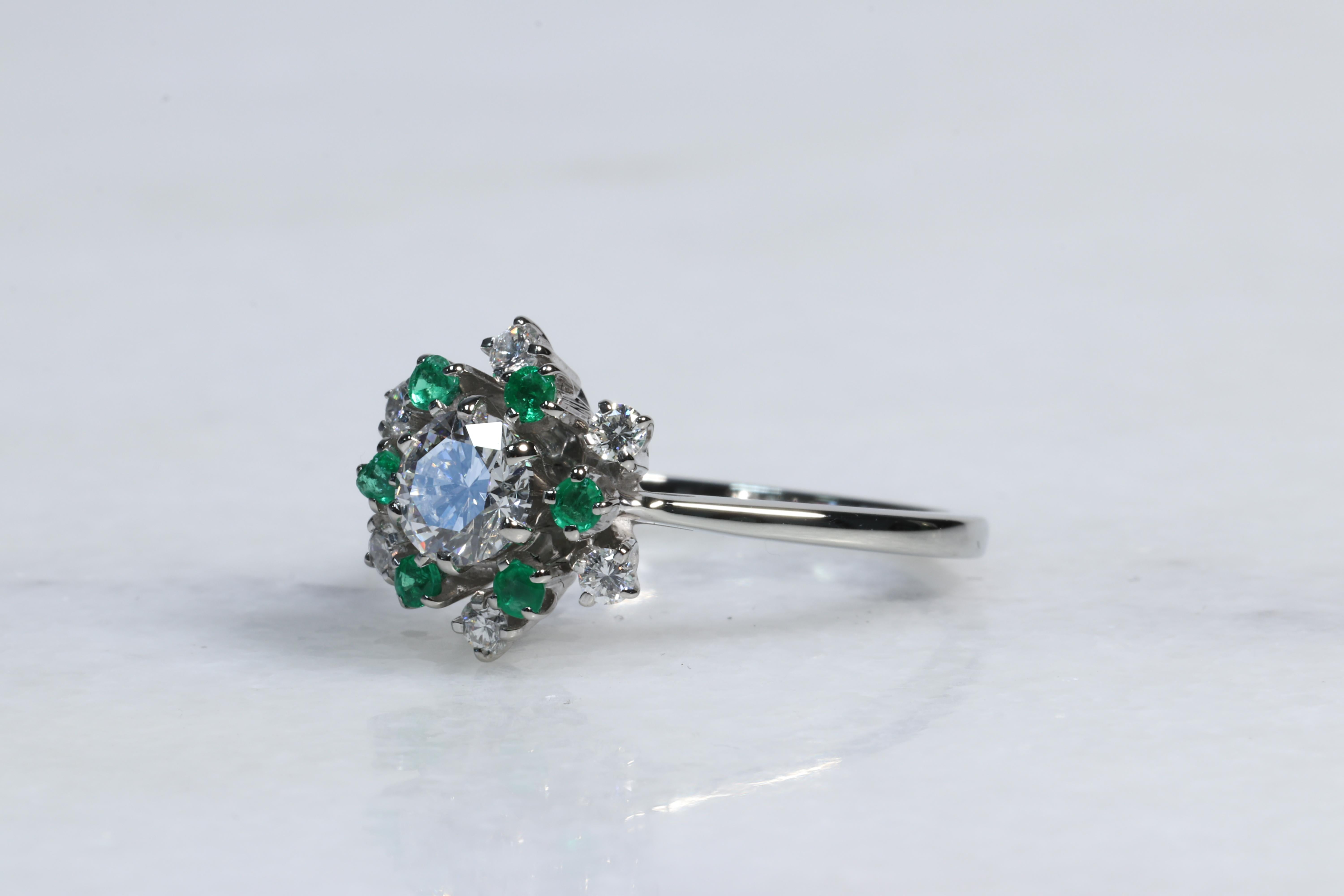 Jabel Diamond and Emerald Halo Snowflake Ring 

Cute and dainty diamond and emerald ring by Jabel, a company known for their fine craftsmanship and materials utilized in their heirloom quality jewelry, likened to Tiffany & Co. The ring features a