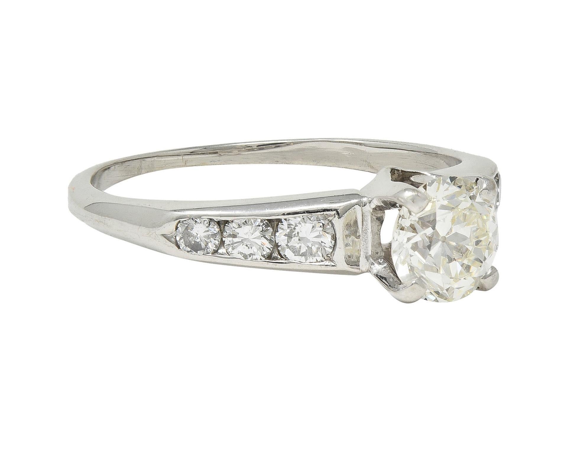 Centering an old European cut diamond weighing approximately 0.77 carat total - K color with VS1 clarity
Prong set in a 'V' motif basket and flanked by channel set transitional cut diamonds
Weighing approximately 0.44 carat total - H/I color with