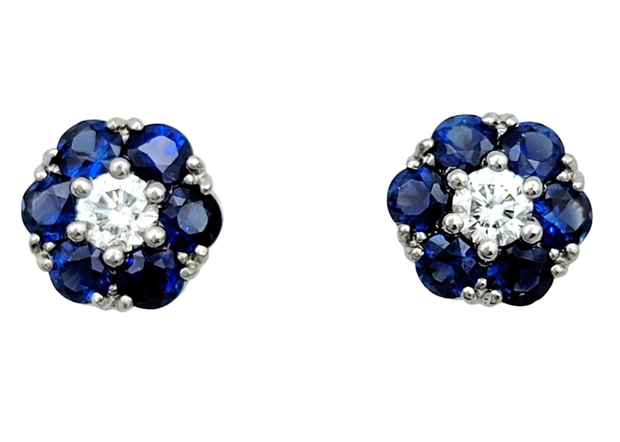 These charming Jabel stud earrings are a captivating display of floral beauty. Crafted from exquisite 18 karat yellow gold, each earring features a delicate flower motif adorned with vibrant sapphires and sparkling diamonds. The center of each