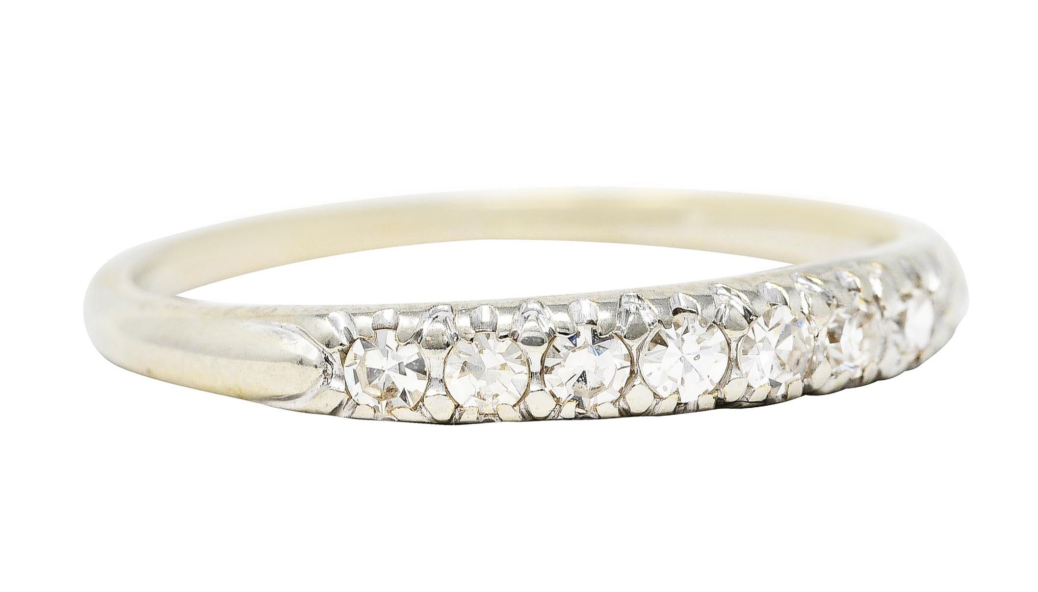 Band ring features a row of front facing single cut diamonds

Highly wrought and set low in band

While weighing in total approximately 0.25 carat - eye clean and bright

Stamped 18K for 18 karat gold

Fully signed Jabel

Circa: 1930s

Ring Size: 5