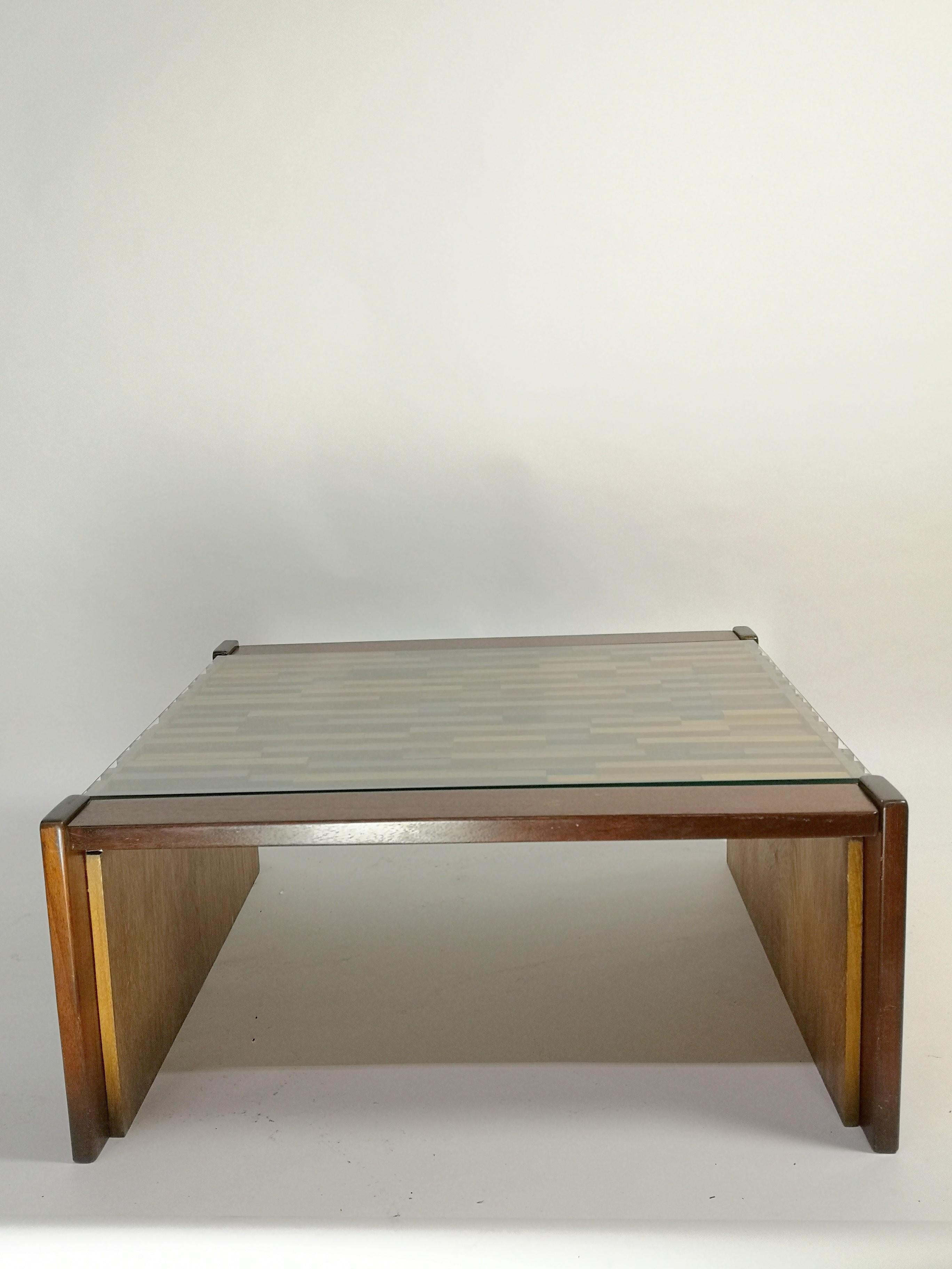 Designed by Percival Lafer, this table is marked and manufactured in Brazil during the 1960s. The table made of rosewood, teak, and jacaranda. It has a thick glass top the table is in original condition, with some minor surface damage, otherwise