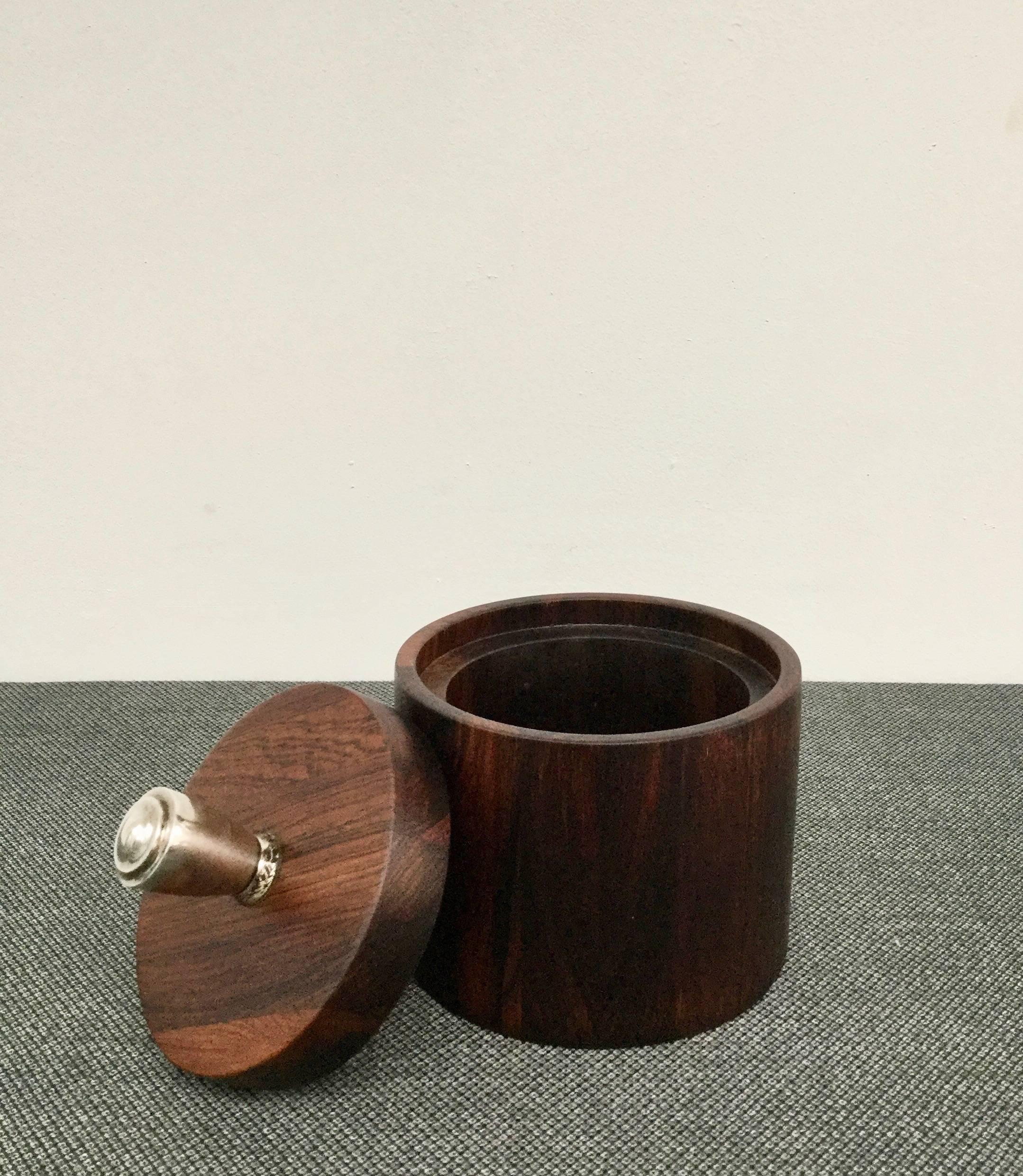 Collectable solid jacaranda wooden pot with a sterling (925 marked) handgrip by Jean Gillon. Made 1960 by Italma Wood Art, Brazil.

Originally designed as a tobacco pot but now serves as a high quality decorative interior object.


