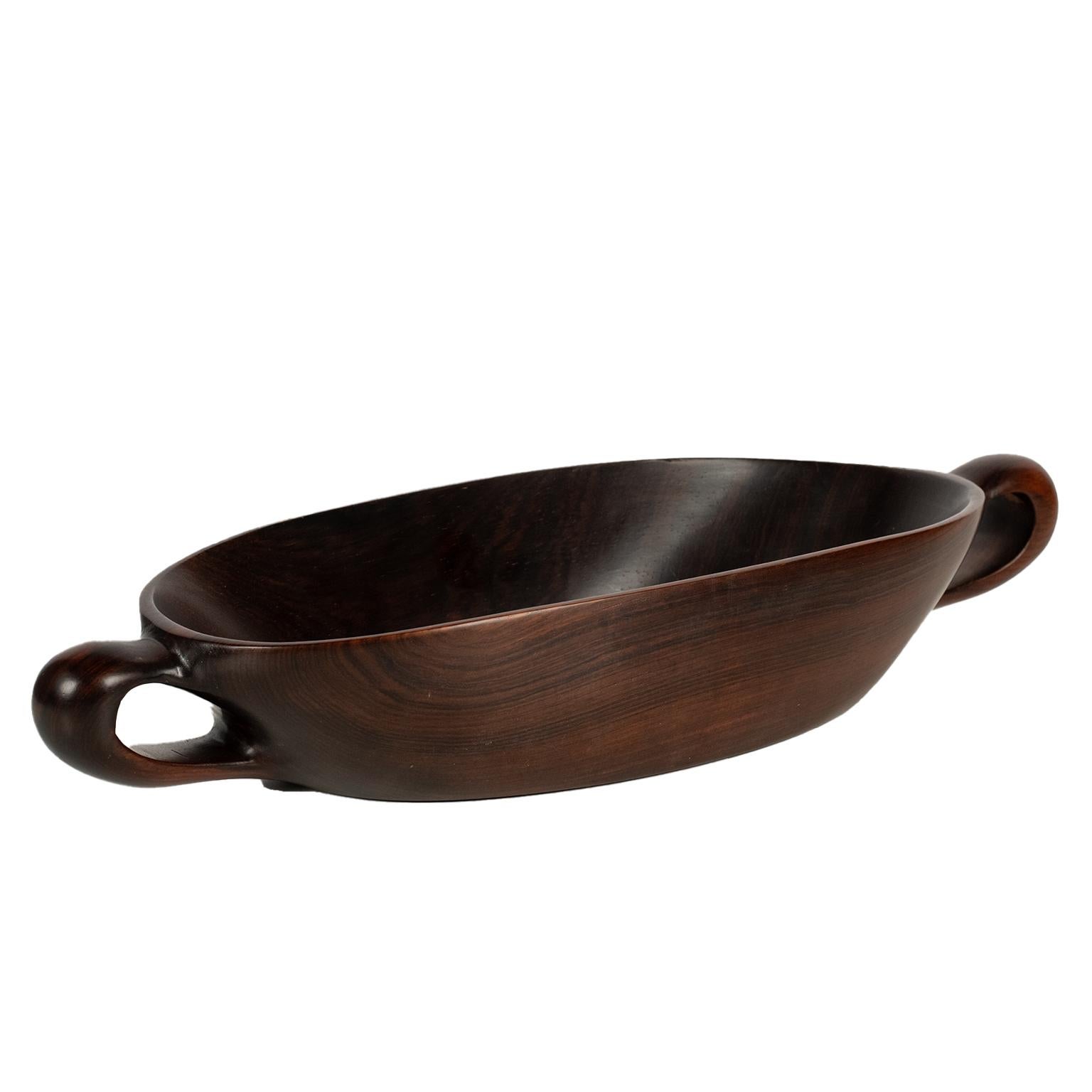 This is a masterful, smooth, exotic and beautifully hand carved Jacaranda wood bowl by Brazillian design icon Jean Gillon for Wood Art. It bears its original production label classifying it as 1/505. A rare beauty and perfect collectible for those