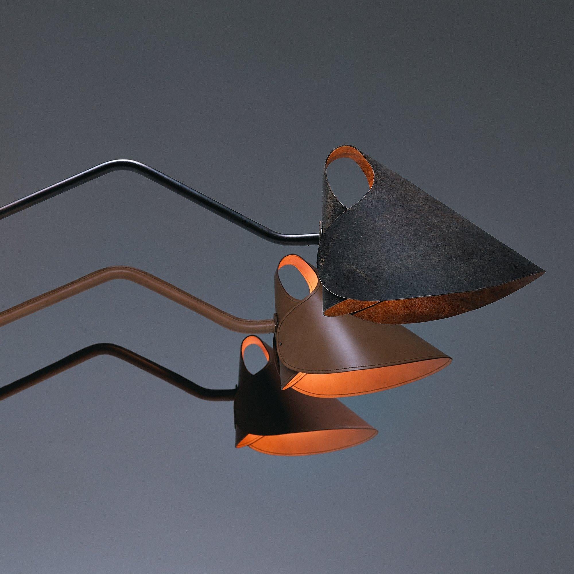 Is there any question why the Mrs. Q wall fixture has curled its way into the hearts of design savants the world over? This kicky creation, designed by Jacco Maris, has a fabulous folded leather shade, available in five colors, perched upon a